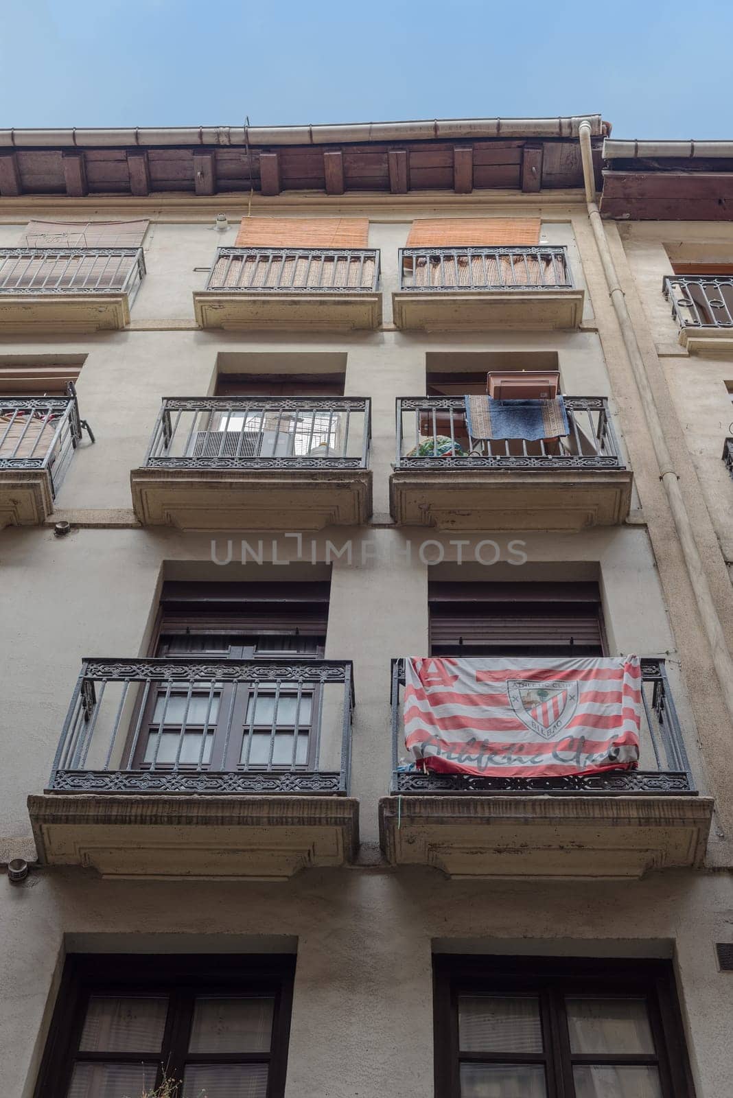 House facade with flag Athletic Bilbao in the old town of Bilbao, Spain