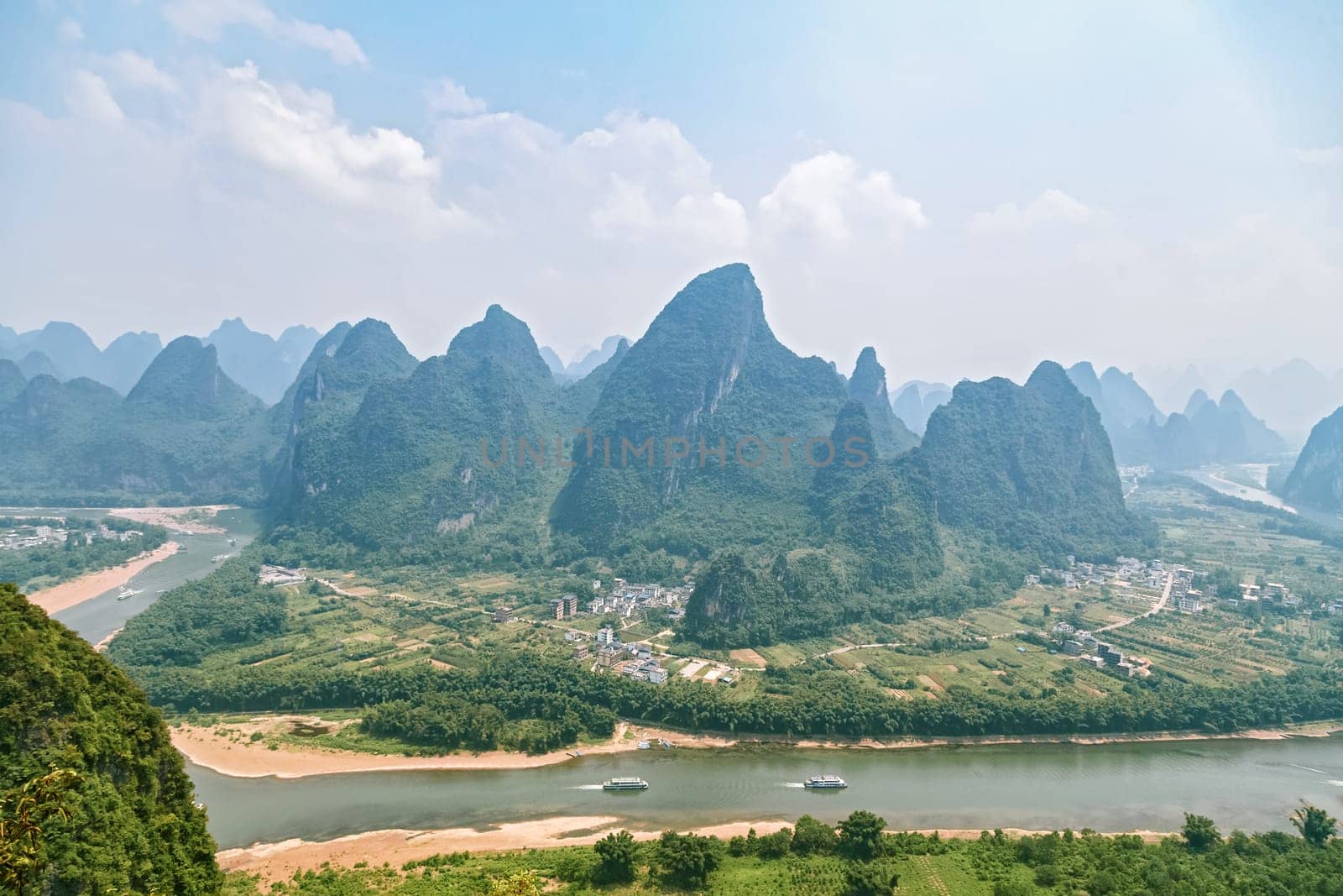 Picturesque mountain valleys of Yangshuo, Guilin, navigable river among the mountains, tourist route 22.08.2019