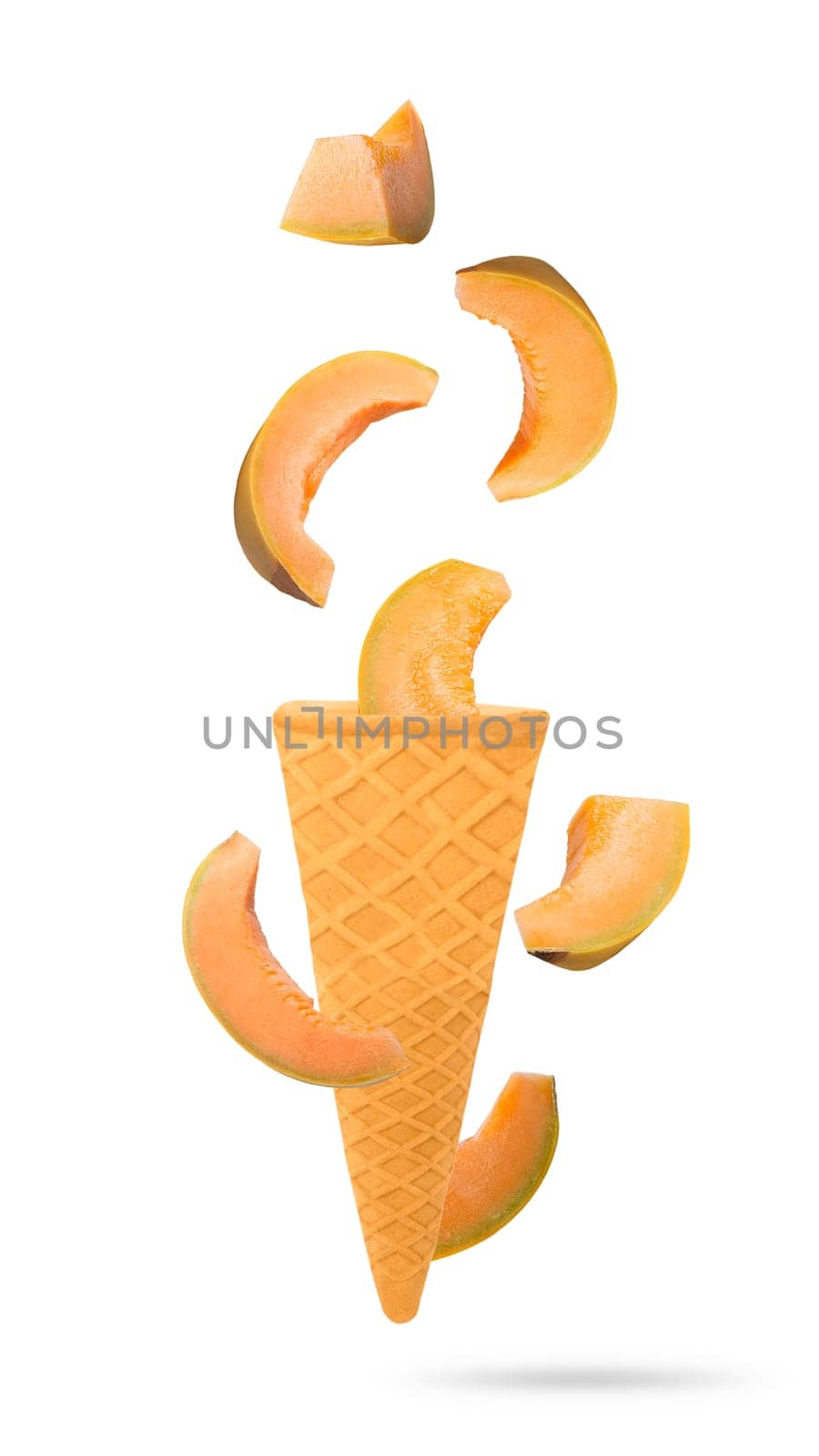Isolated flying fruit. Seven slices of yellow melon fruits falling down in ice cream cone with clipping path. Accurate retouching fruits for package design element. Full depth of field.