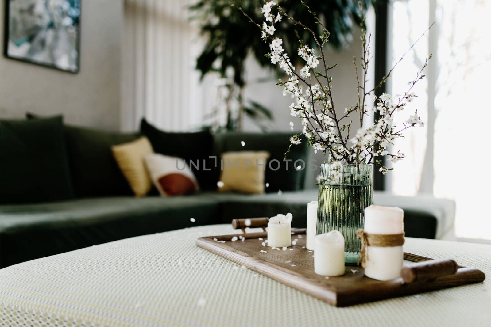 Home interior. Relaxing candles. Apple tree color has flown. Blurred background. High quality photo
