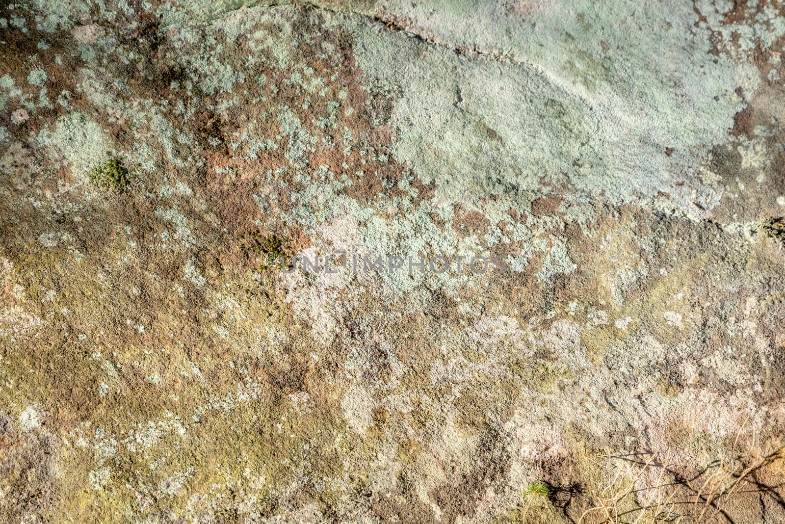Even sandstone rocks with moss and lichen overgrown as background