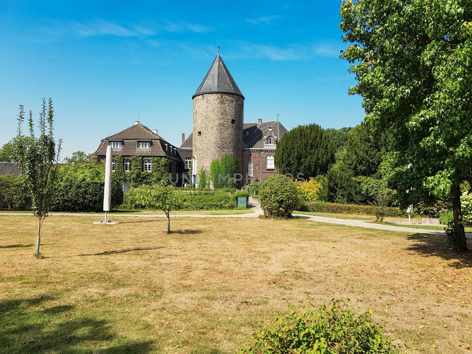 RATINGEN, NRW, GERMANY - AUGUST 22, 2018:.View of the mansion, from Linnep Castle. Old moated castle, side view to the castle on a sunny day.