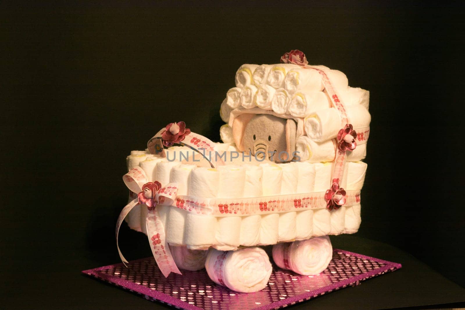HEILIGENHAUS, NRW, GERMANY - JANUARY 16, 2019:.Newborn gift concept. Cake of diapers. Packed diapers as a stroller