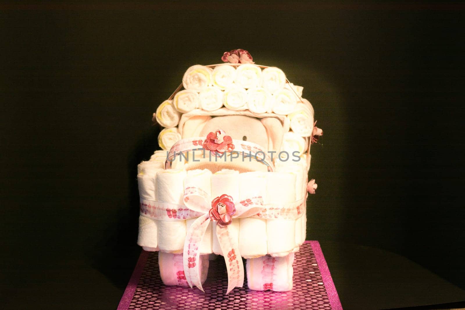 HEILIGENHAUS, NRW, GERMANY - JANUARY 16, 2019:.Newborn gift concept. Cake of diapers. Packed diapers as a stroller