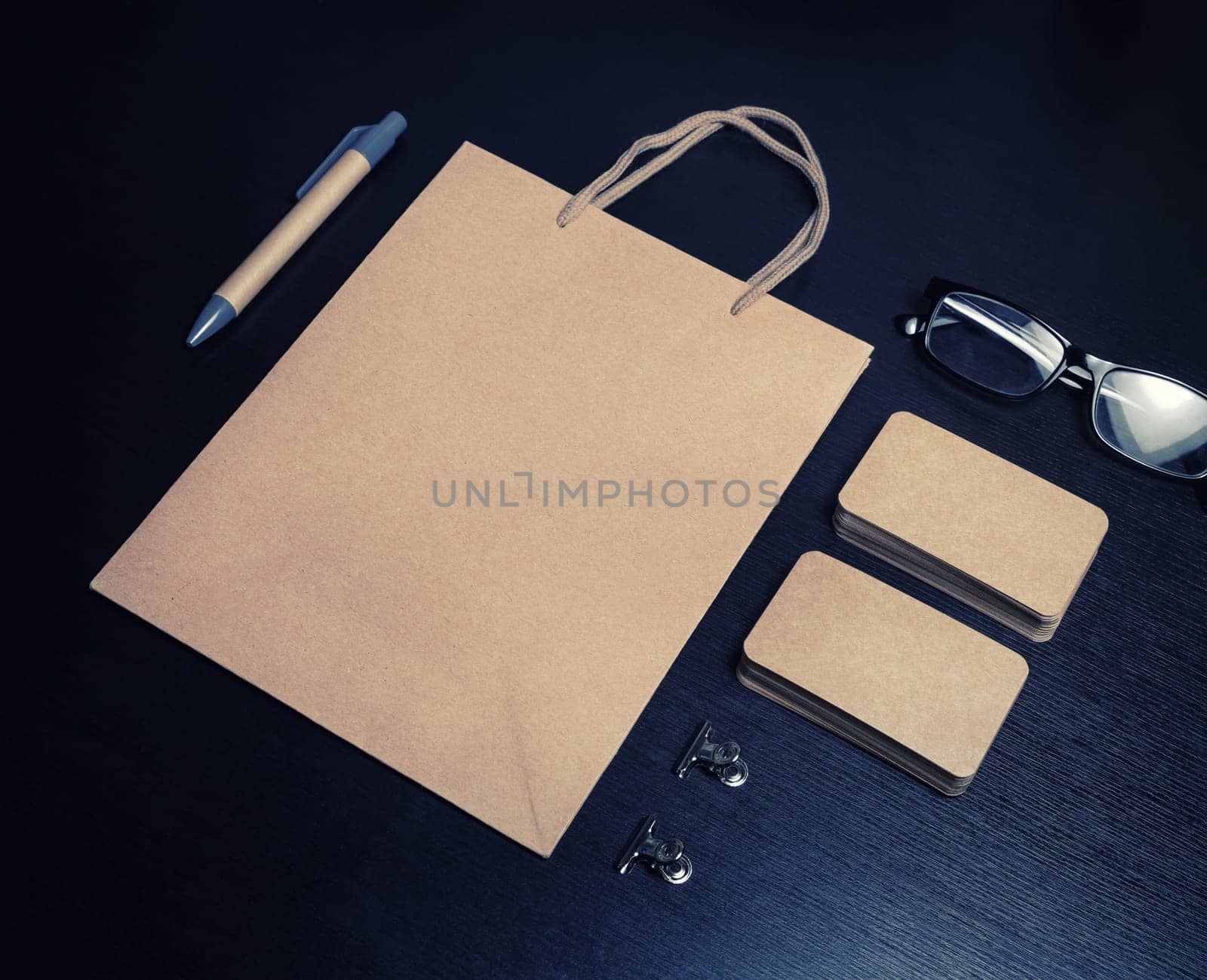 Kraft corporate identity template on wooden background. Photo of blank stationery set. Mockup for design presentations and portfolios.