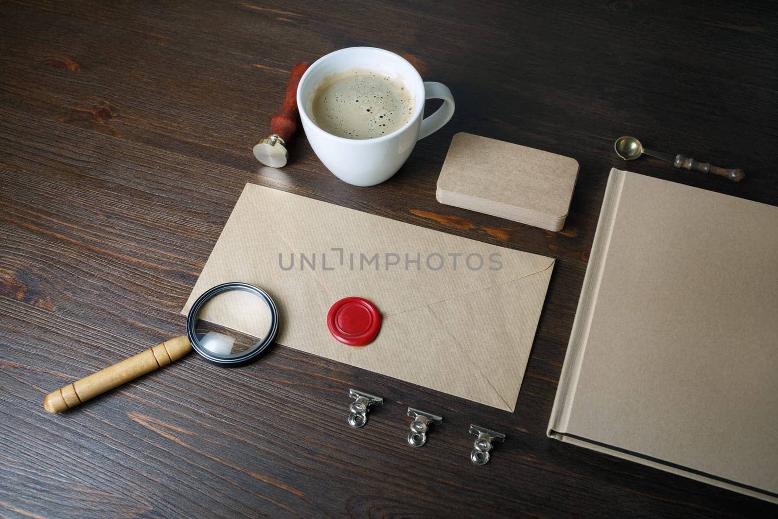 Photo of blank vintage stationery elements on wood table background. Responsive design mockup. ID template.