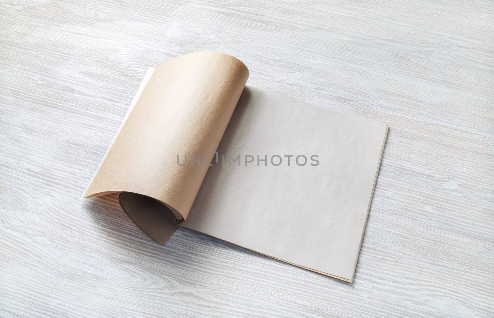 Blank magazine template on wood table background. Responsive design mockup.