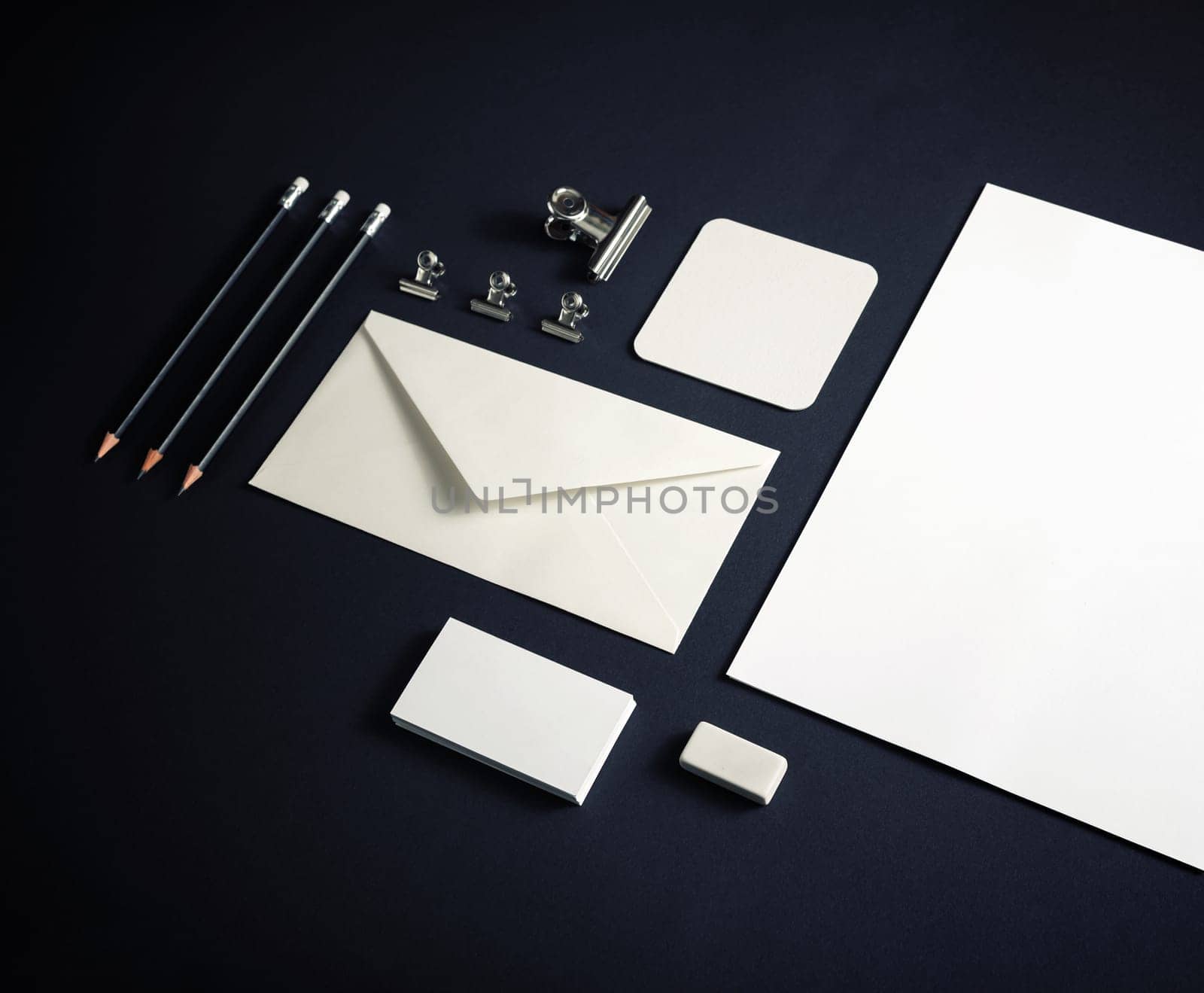 Blank corporate stationery set on black paper background. Corporate identity template. Responsive design mockup.