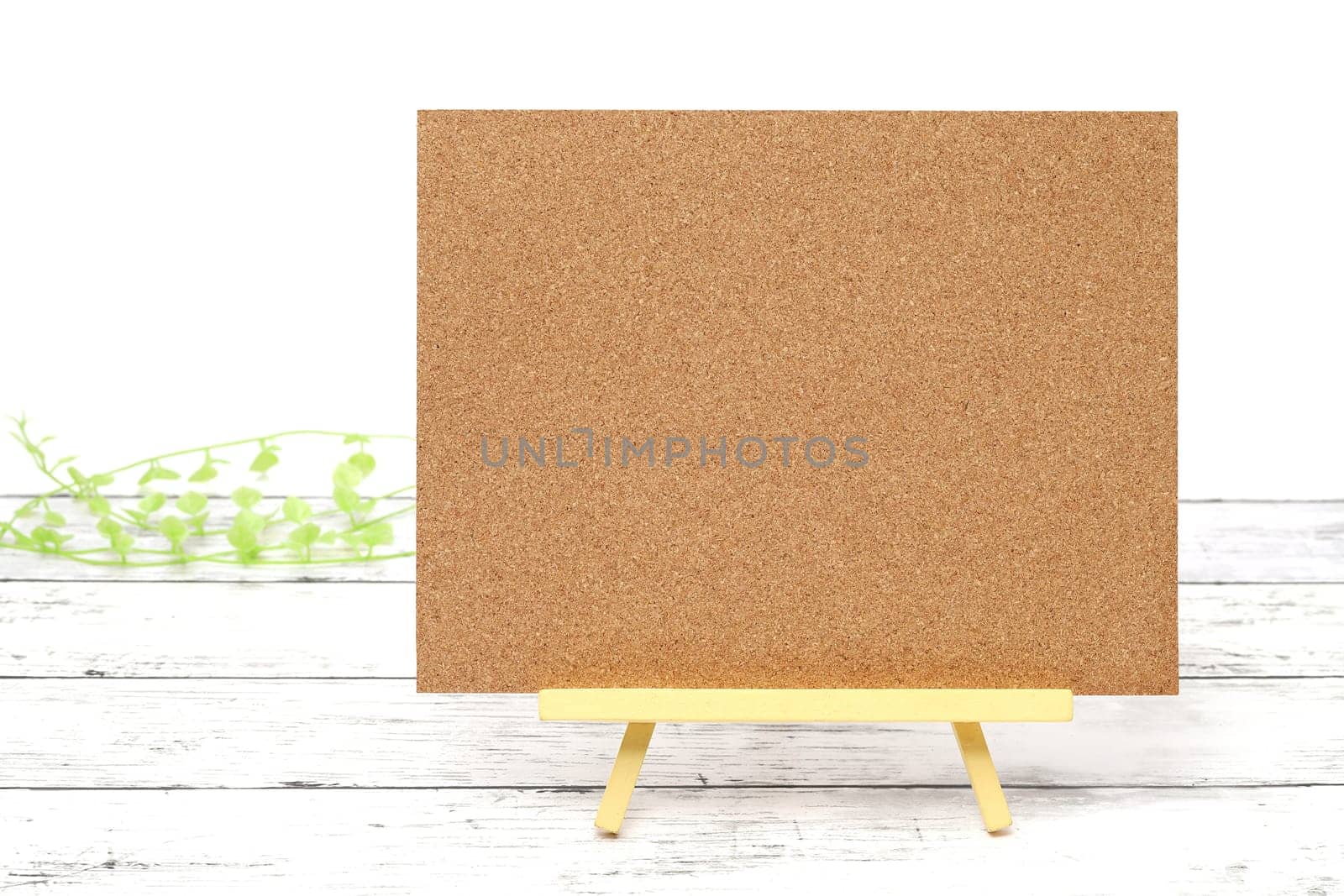 Wooden easel and blank board on a white wooden table