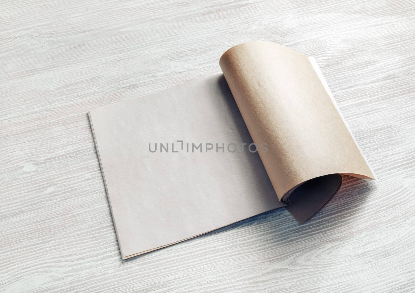 Blank magazine or brochure on wooden background.