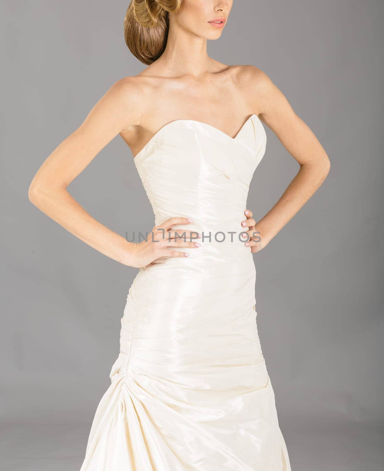 Beautiful bride on grey background. Studio shot