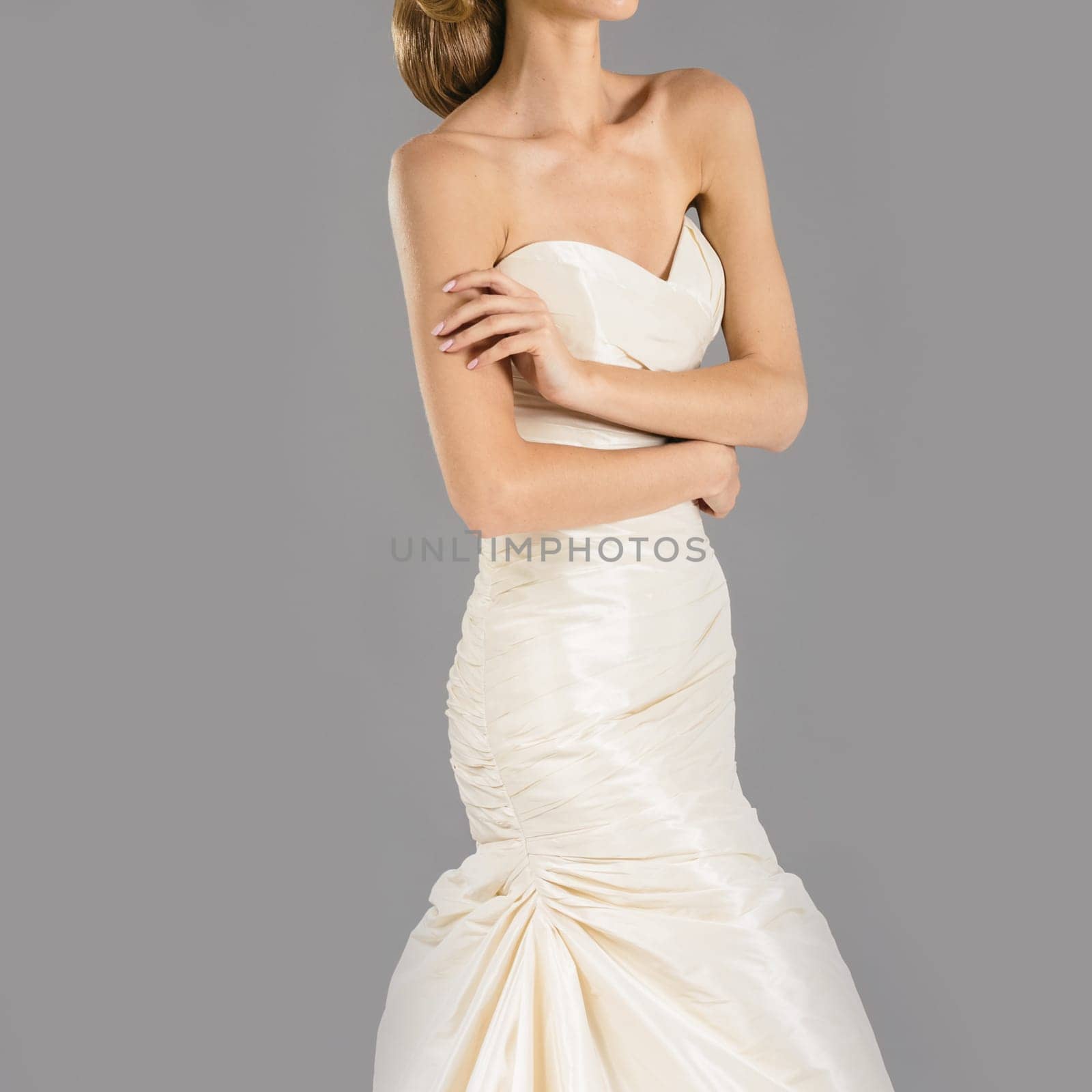 Beautiful bride on grey background. Studio shot