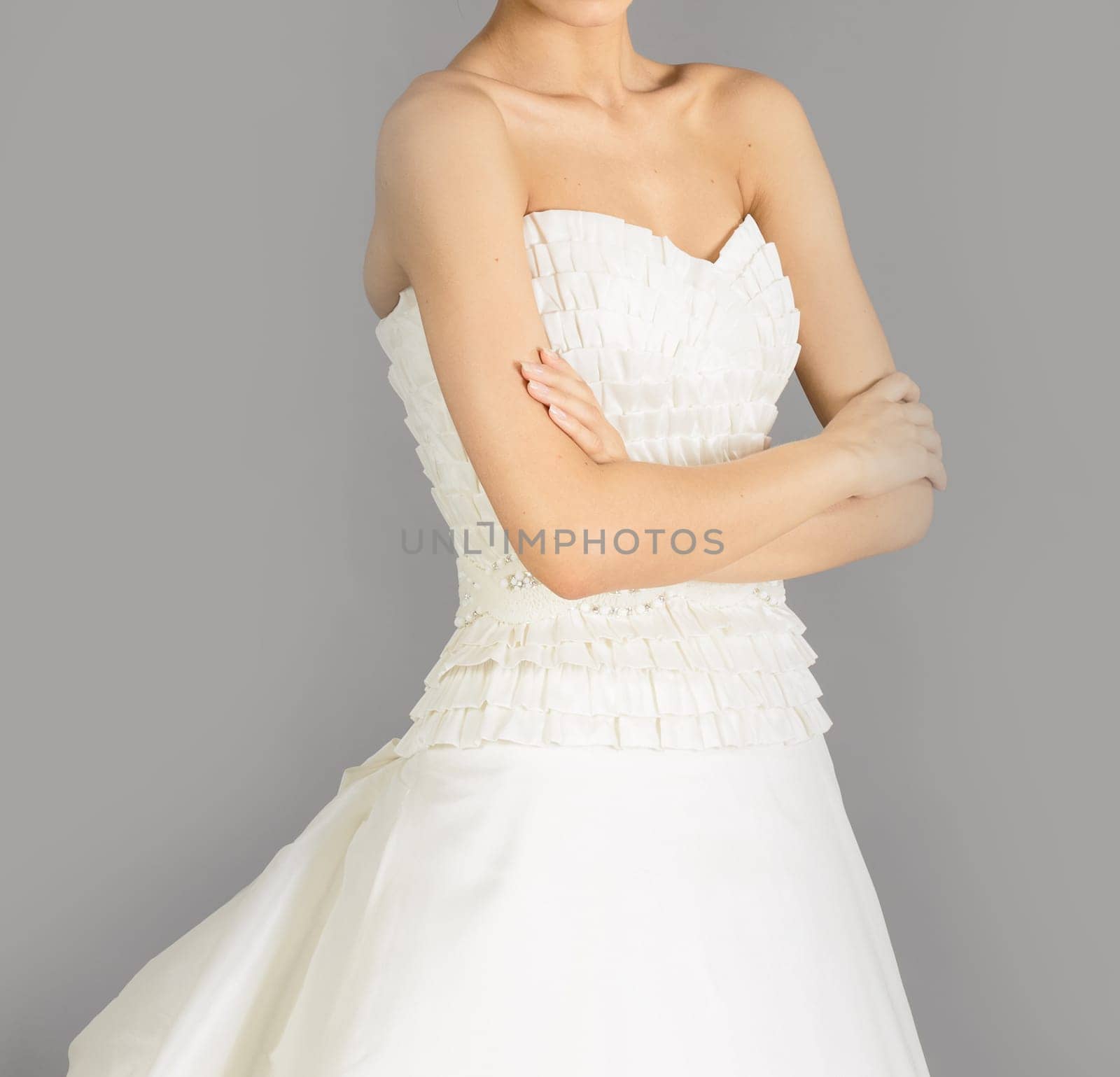 Beautiful bride on grey background. Studio shot