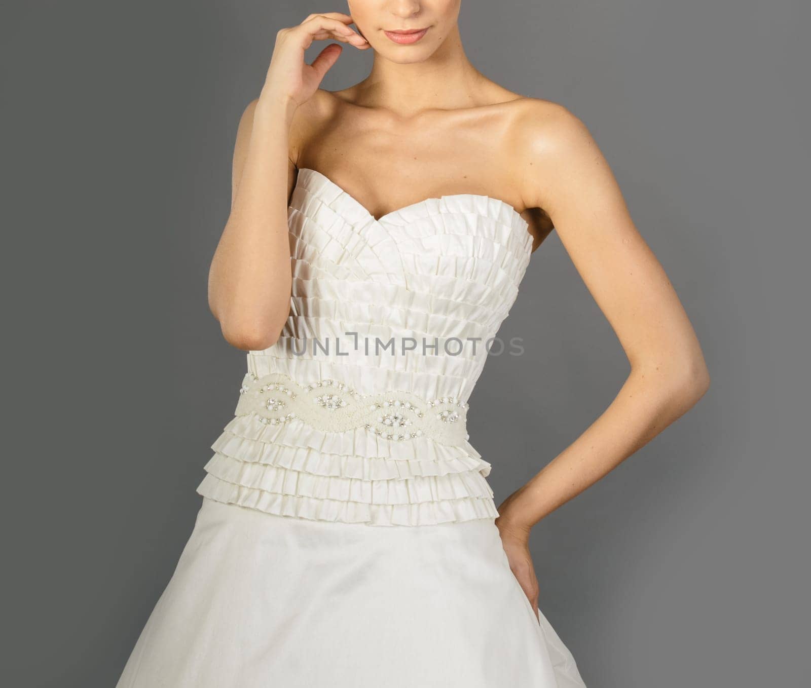 Beautiful bride on grey background. Studio shot