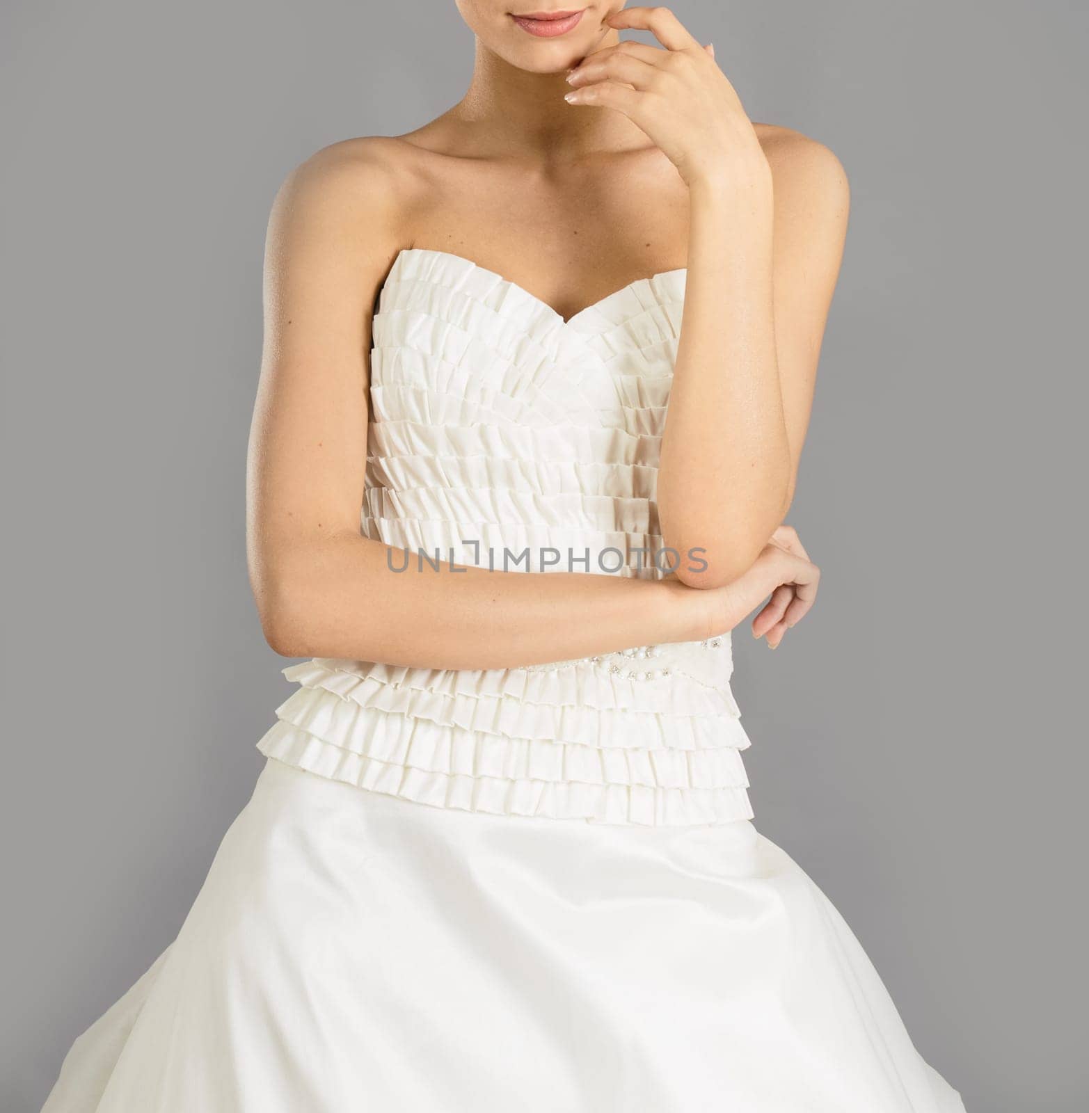 Beautiful bride on grey background. Studio shot