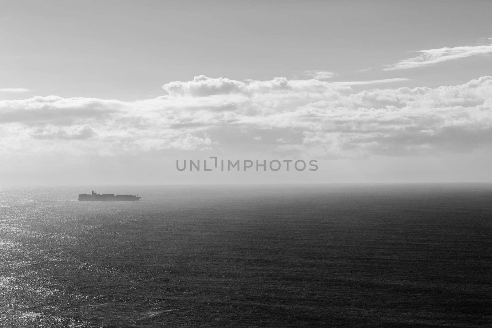 Ship travels open ocean seas overlooking birds-eye in black white vintage contrasts
