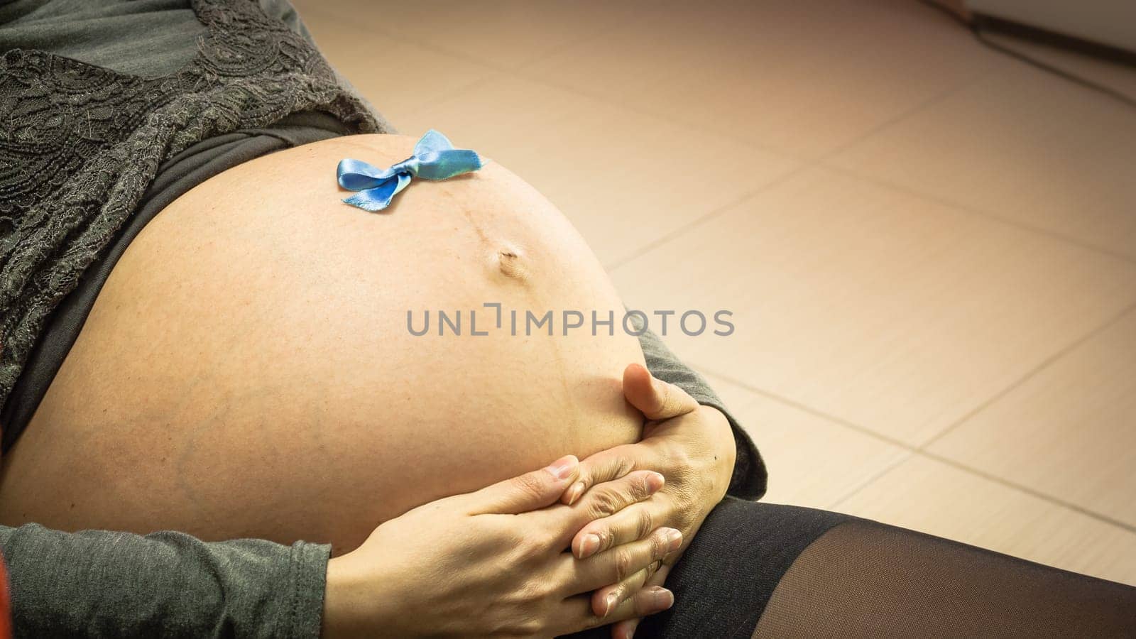 Blue Ribbon in a Pregnant Belly. Expecting a boy