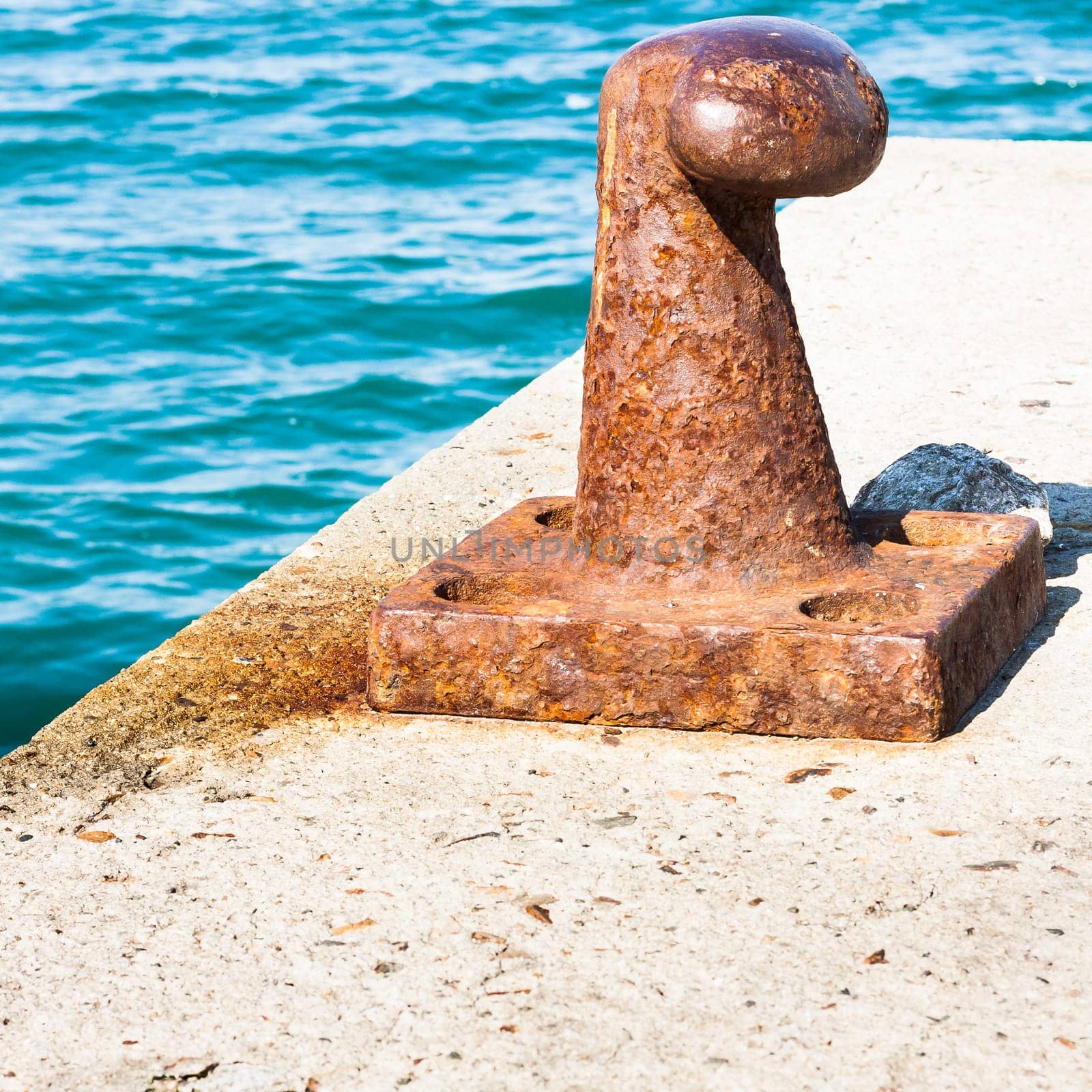 Rusty bollard for mooring boats .