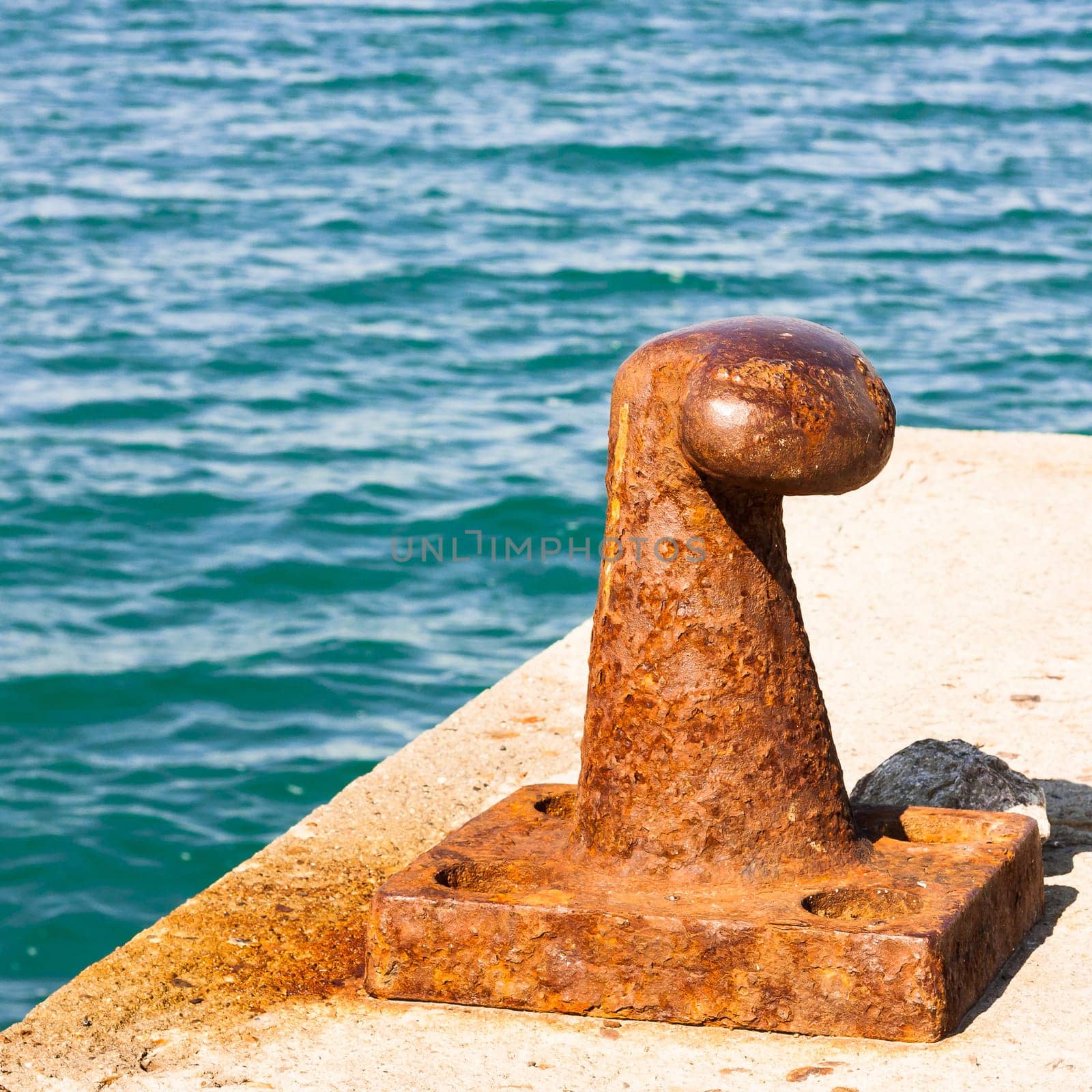 Rusty bollard for mooring boats .
