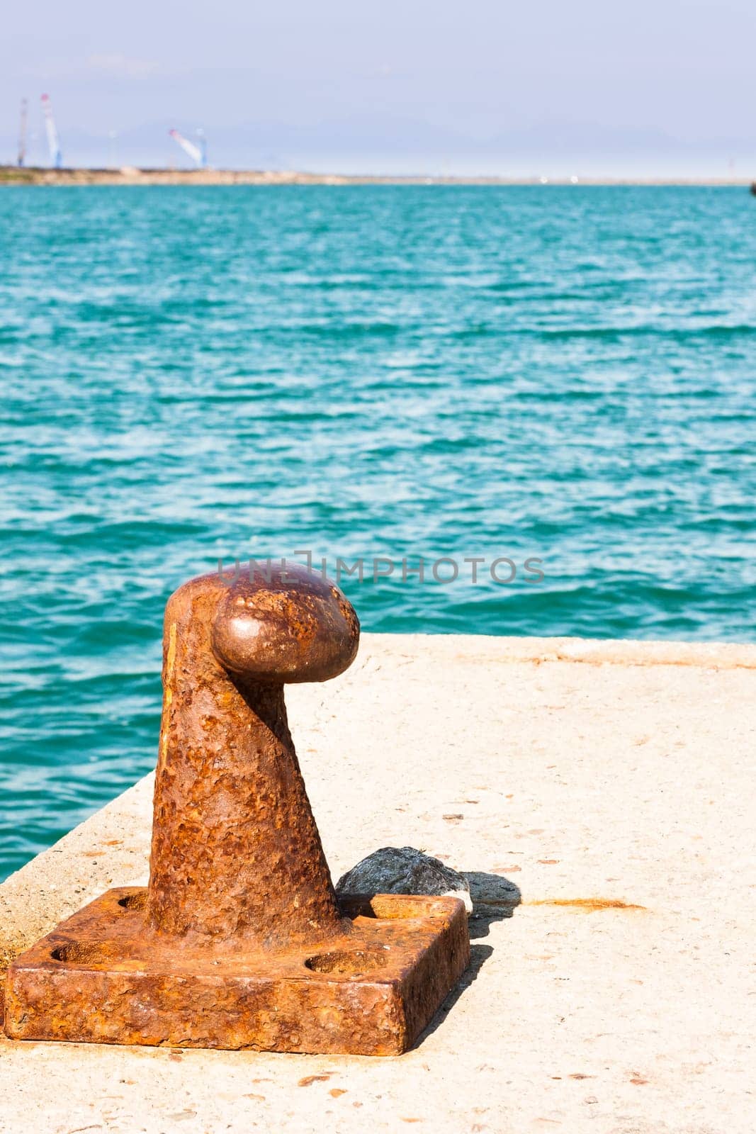 Rusty bollard for mooring boats .