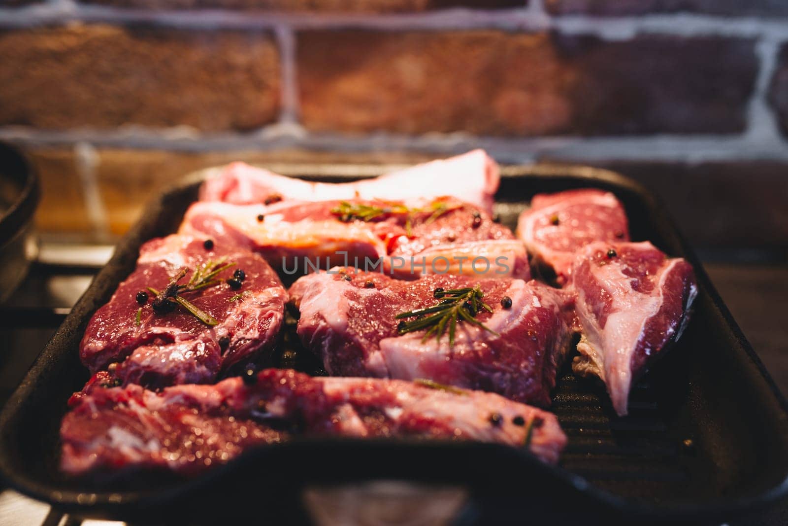 Preparing steak on the grill pan with seasonings. High quality photo