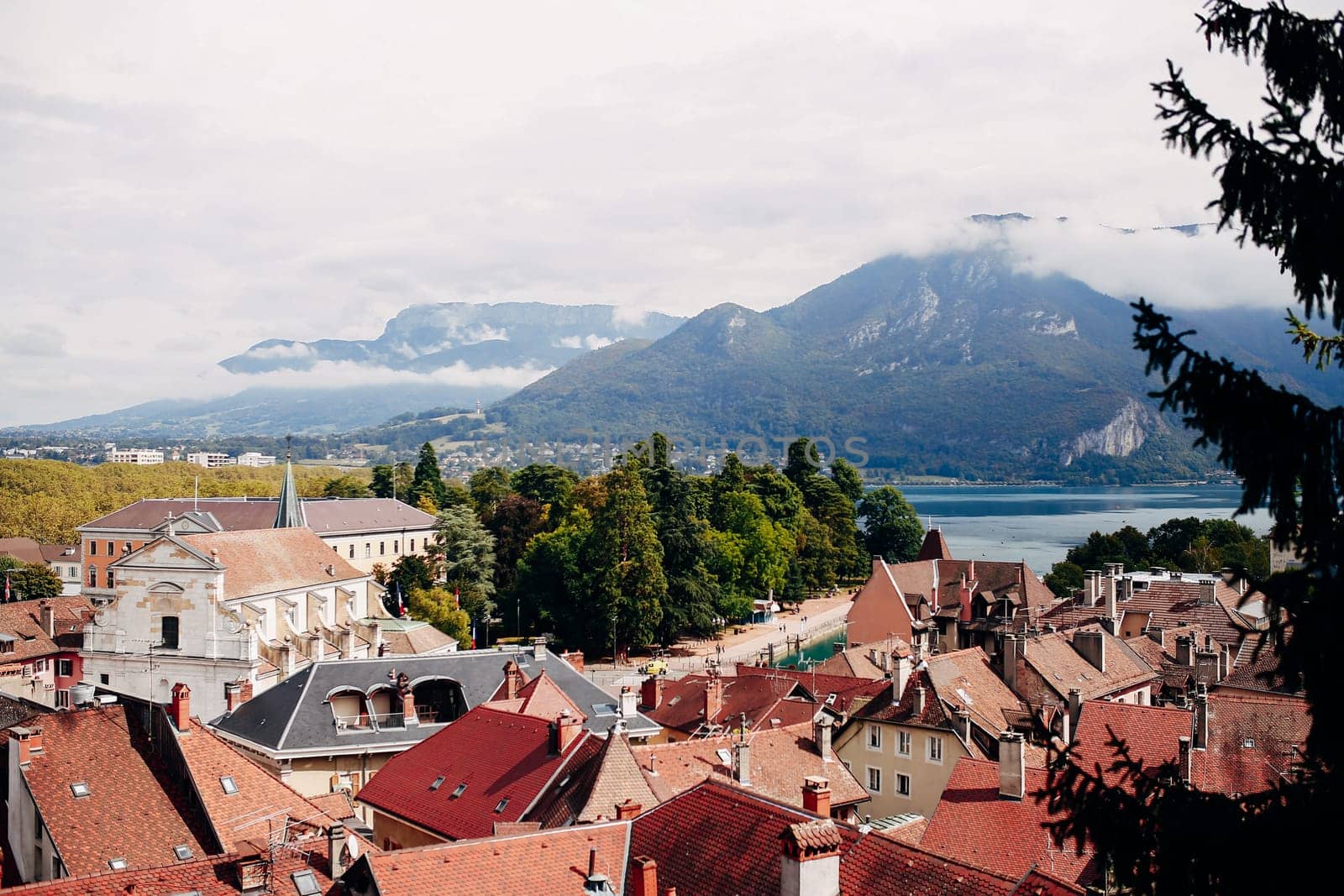 Annecy city top view, lake in the distance. Tile roofs, Cathedral. High quality photo