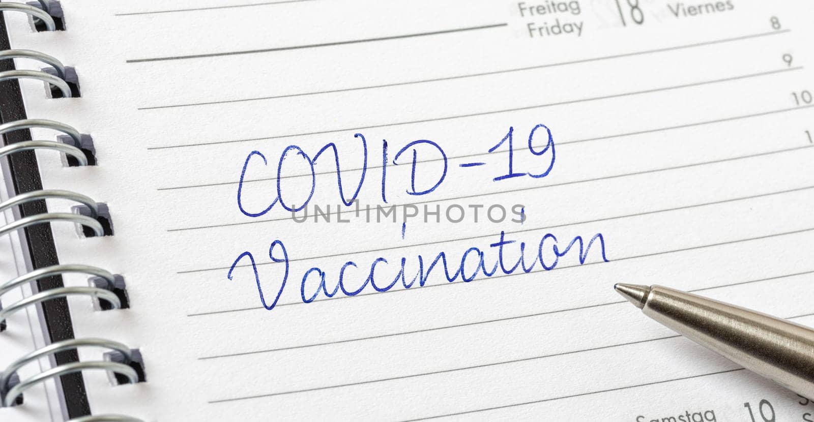 COVID-19 Vaccination written on a calendar page