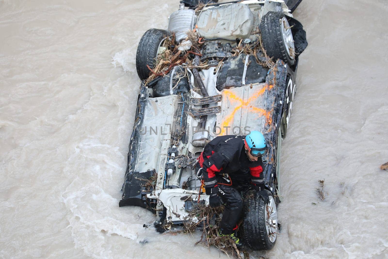 Breil-Sur-Roya, France - October 8, 2020: Rescuer Removing Debris On A Car In The Roya River After Flooding During Storm Alex, Breil-Sur-Roya City In The South Of France, Europe