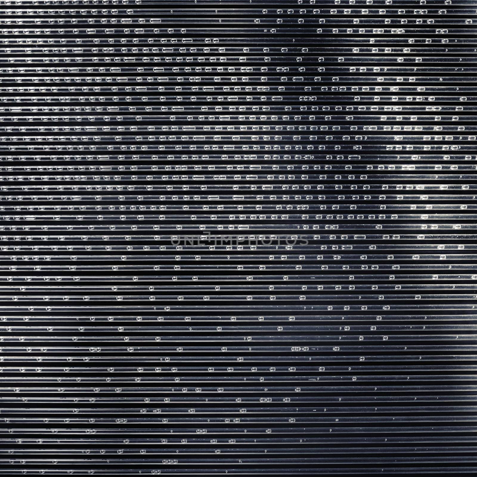 Glass tubes filled with water with air bubbles. Striped tubules. Science concept. Abstract textured background.
