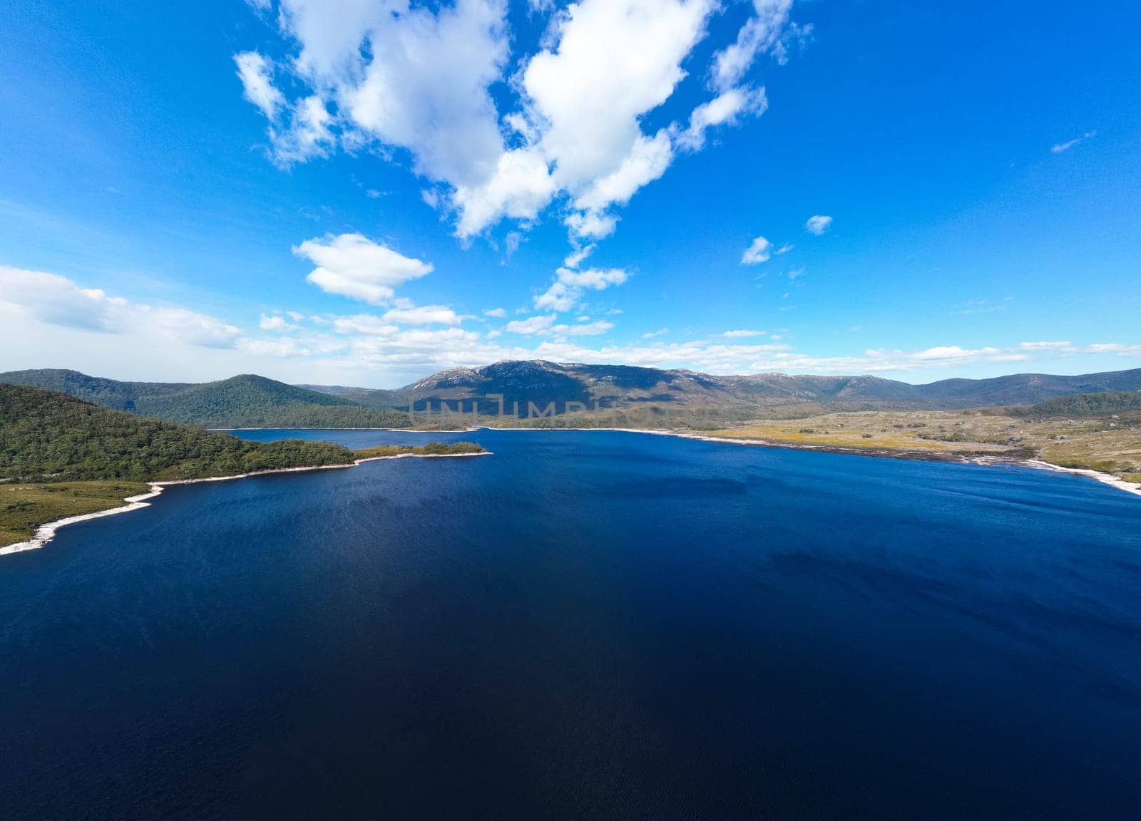 Aerial landscape of Lake Plimsoll on a hot summer's afternoon in Tasmania, Australia