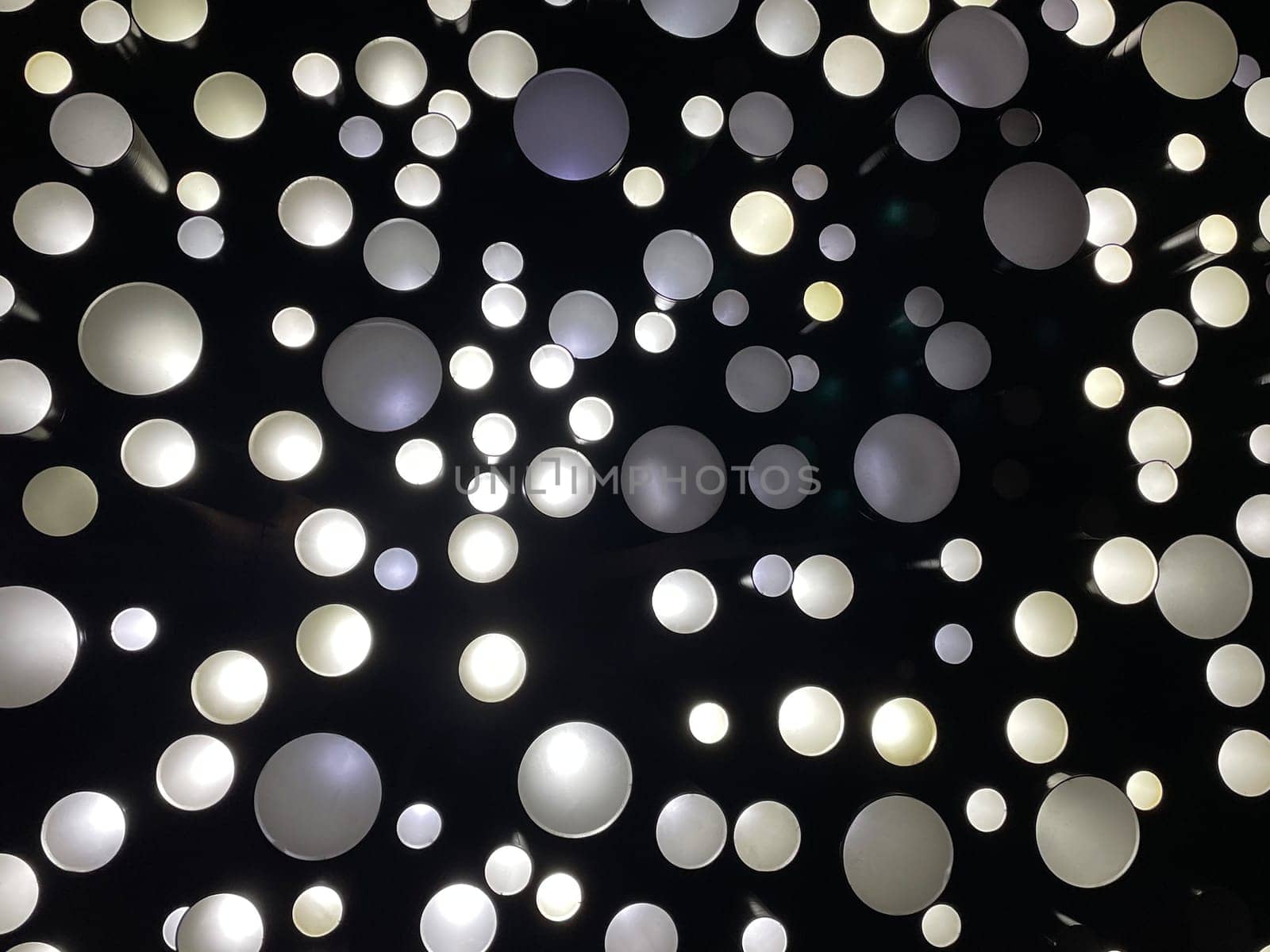 Ceiling multi-colored lamps lighting in the dark - Photo