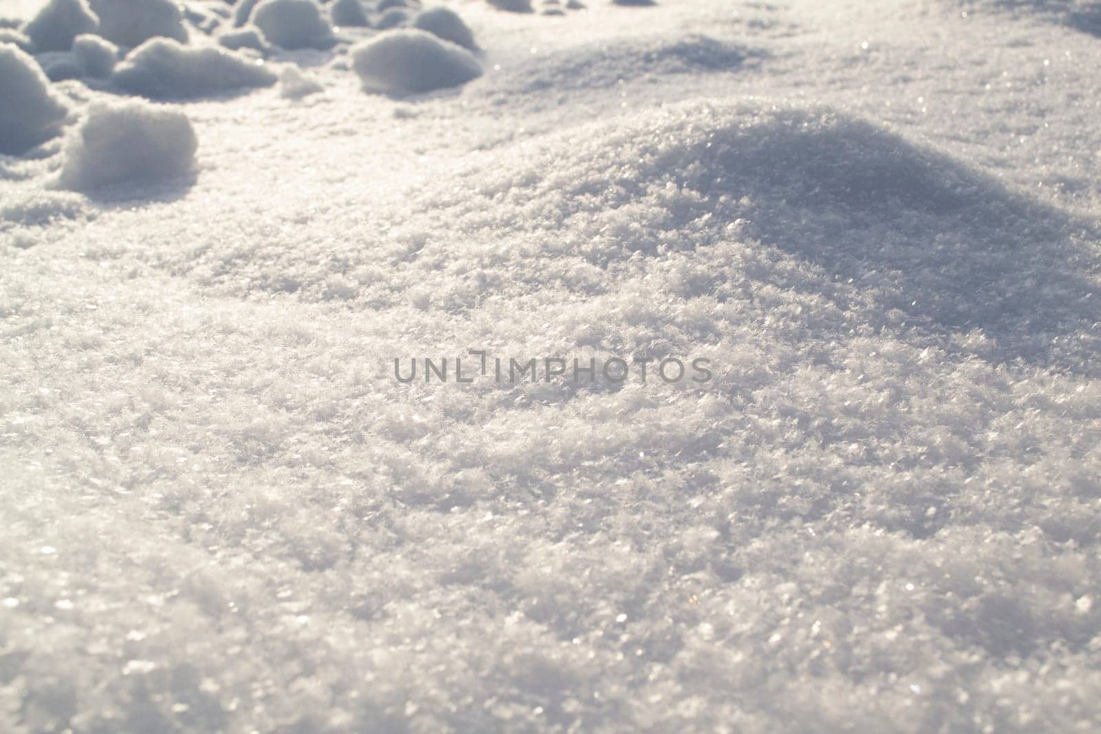 pure white snow sparkles on the sun close up, snowy surface