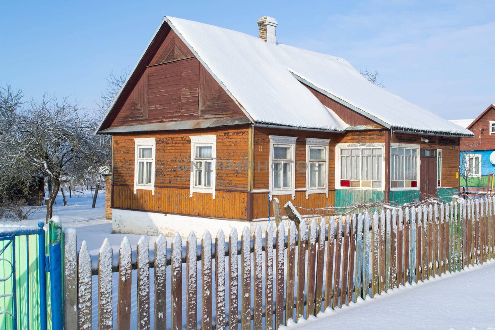 Old wooden house in village. Farmhouse in Belarus. View of rustic ethnic house in winter.