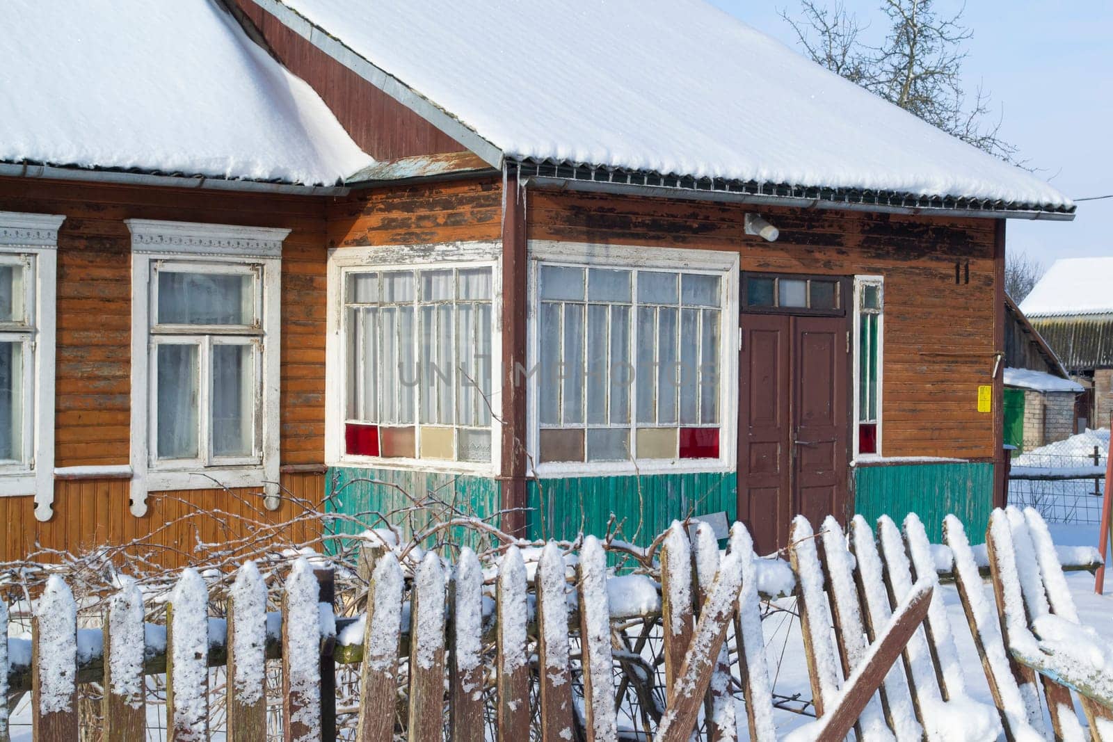 Colorful wooden old house in Belarus winter time, close up