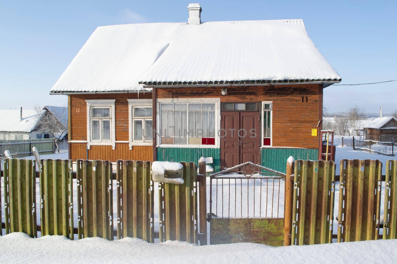 Traditional old log cabin covered with snow, winter sunny day il Belarus