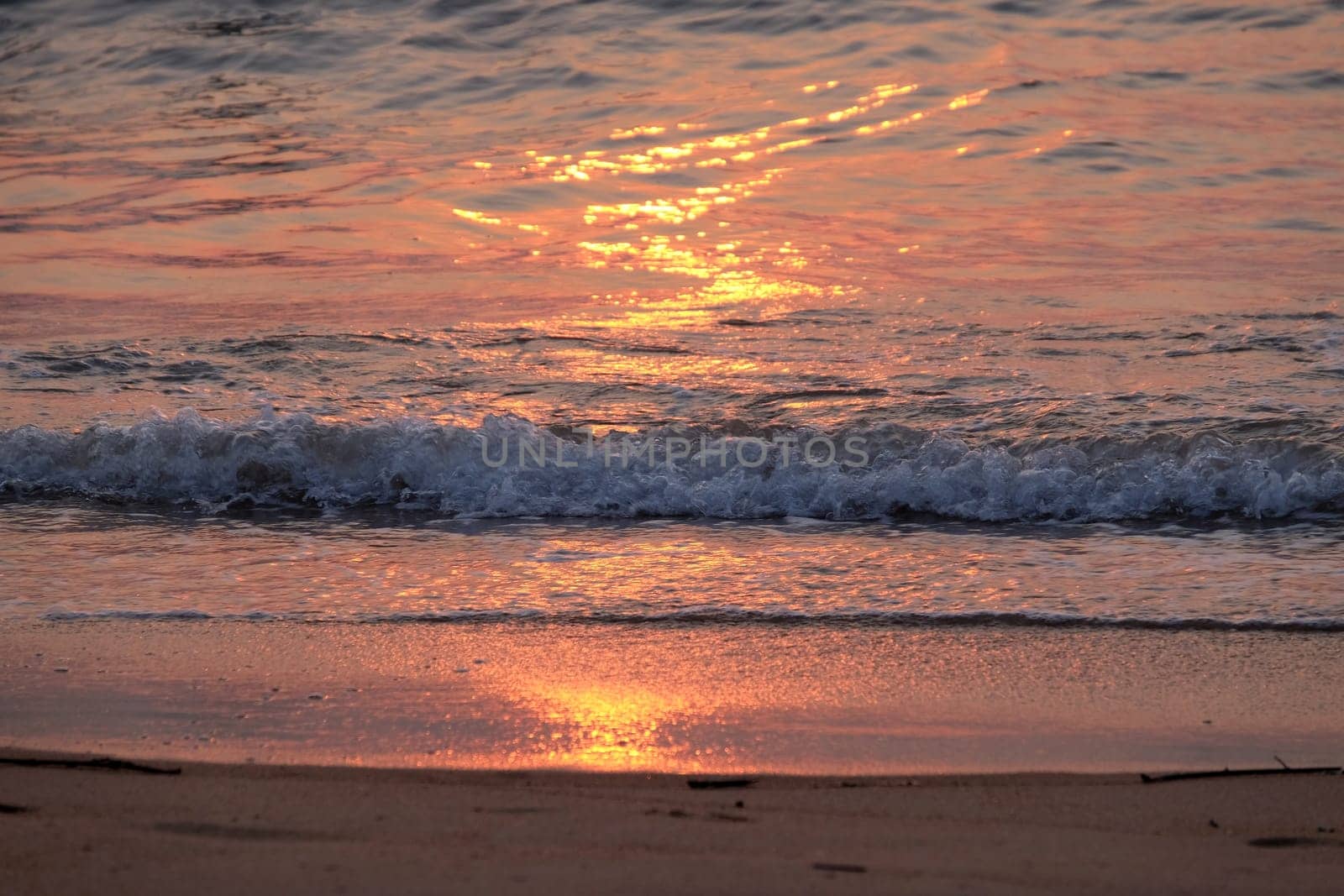 Wave rolling over the sands on Candolim Beach, North Goa, India