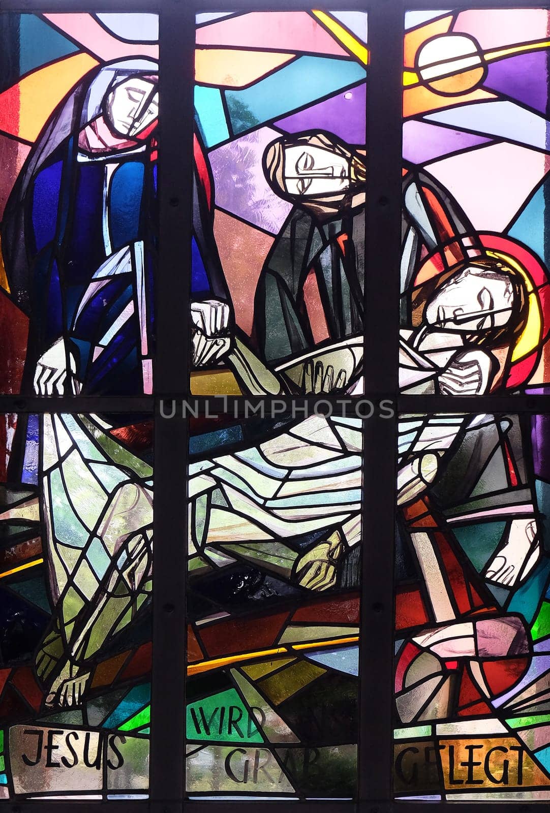 14th Stations of the Cross, Jesus is laid in the tomb and covered in incense, stained glass window in Saint Lawrence church in Kleinostheim, Germany