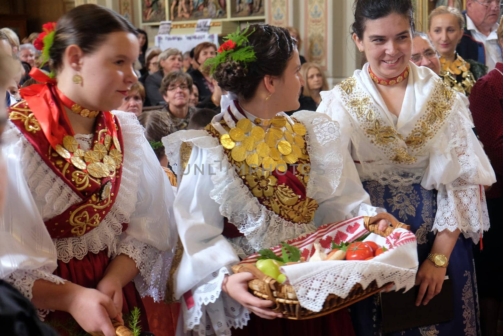 Women dressed in traditional regional folk costumes in the church at the Mass on Thanksgiving day in Stitar, Croatia