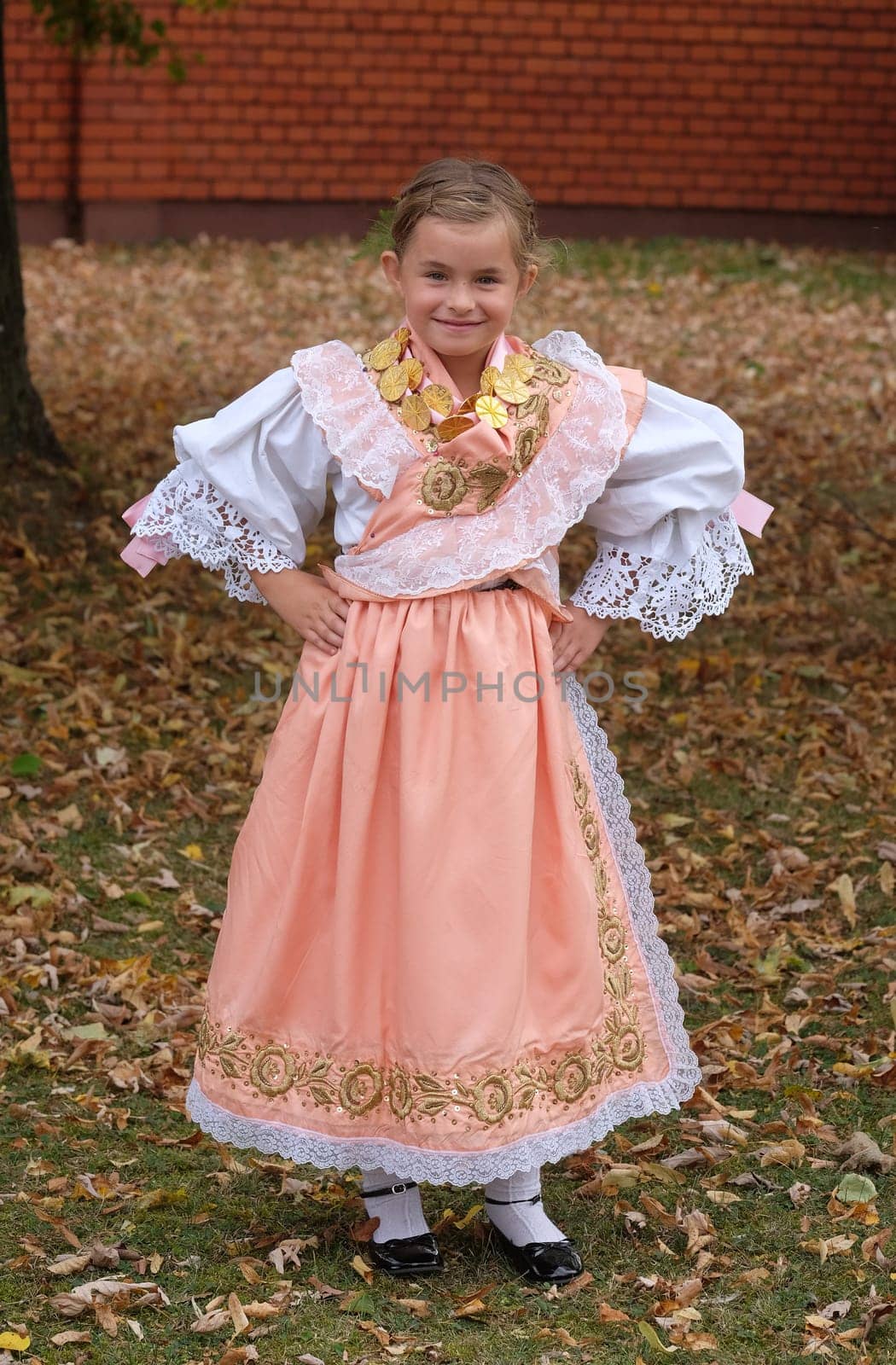 Girl dressed in folk costumes go to the church at the Mass on Thanksgiving day in Stitar, Croatia