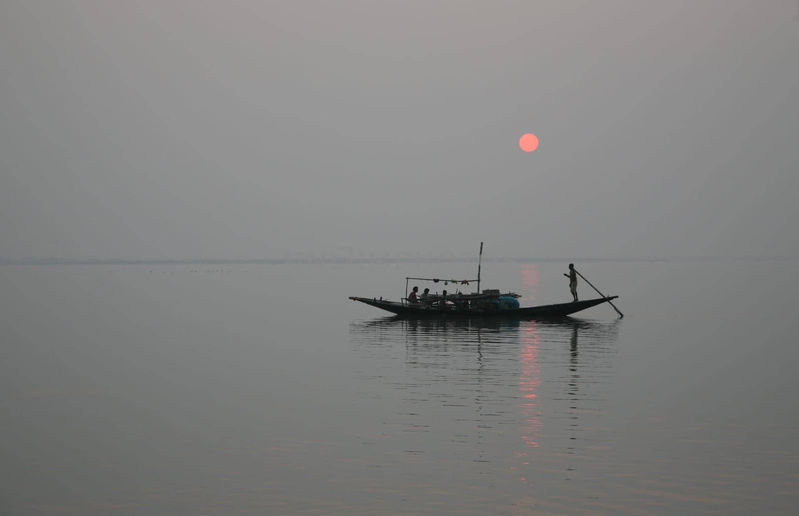 A stunning sunset looking over the holiest of rivers in India. Ganges delta in Sundarbans, West Bengal, India.