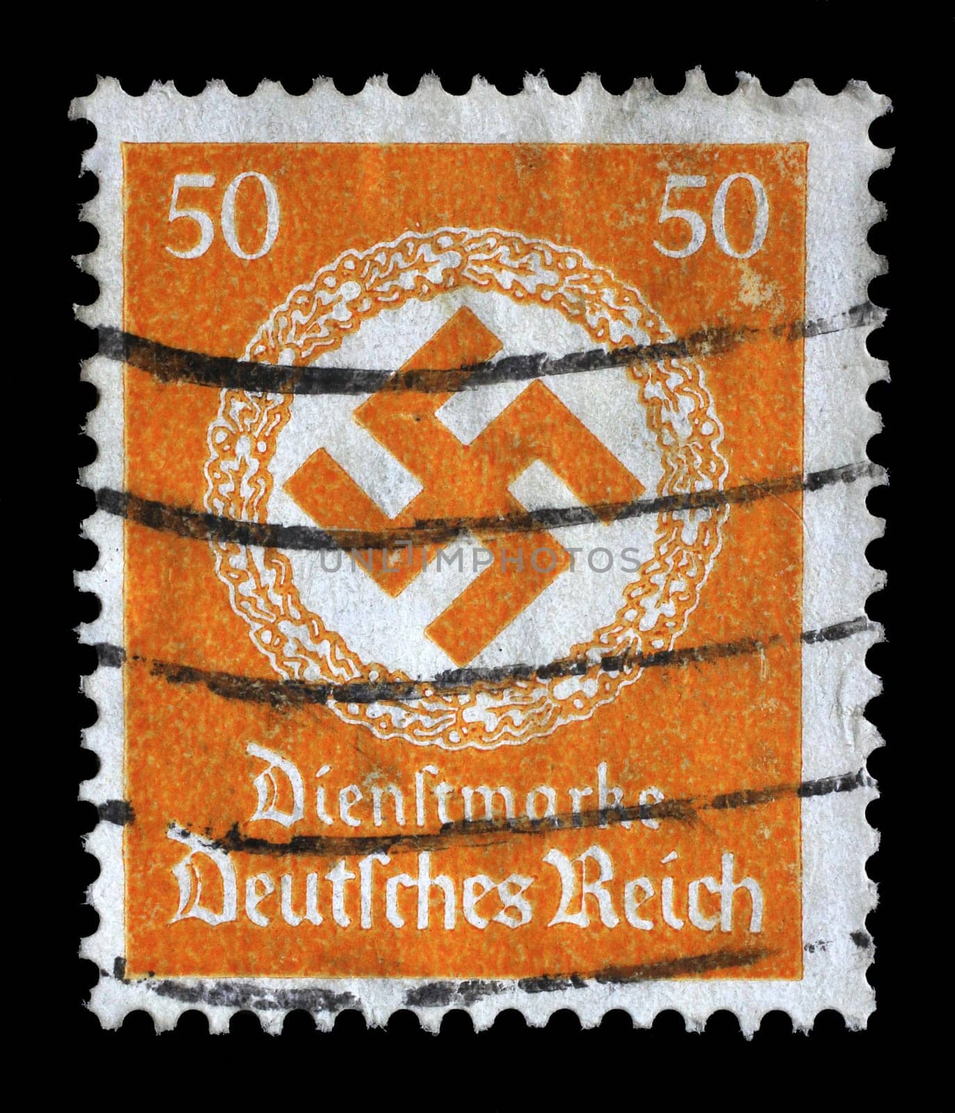 Stamp printed in Germany shows the Swastika in an oak wreath, circa 1942.