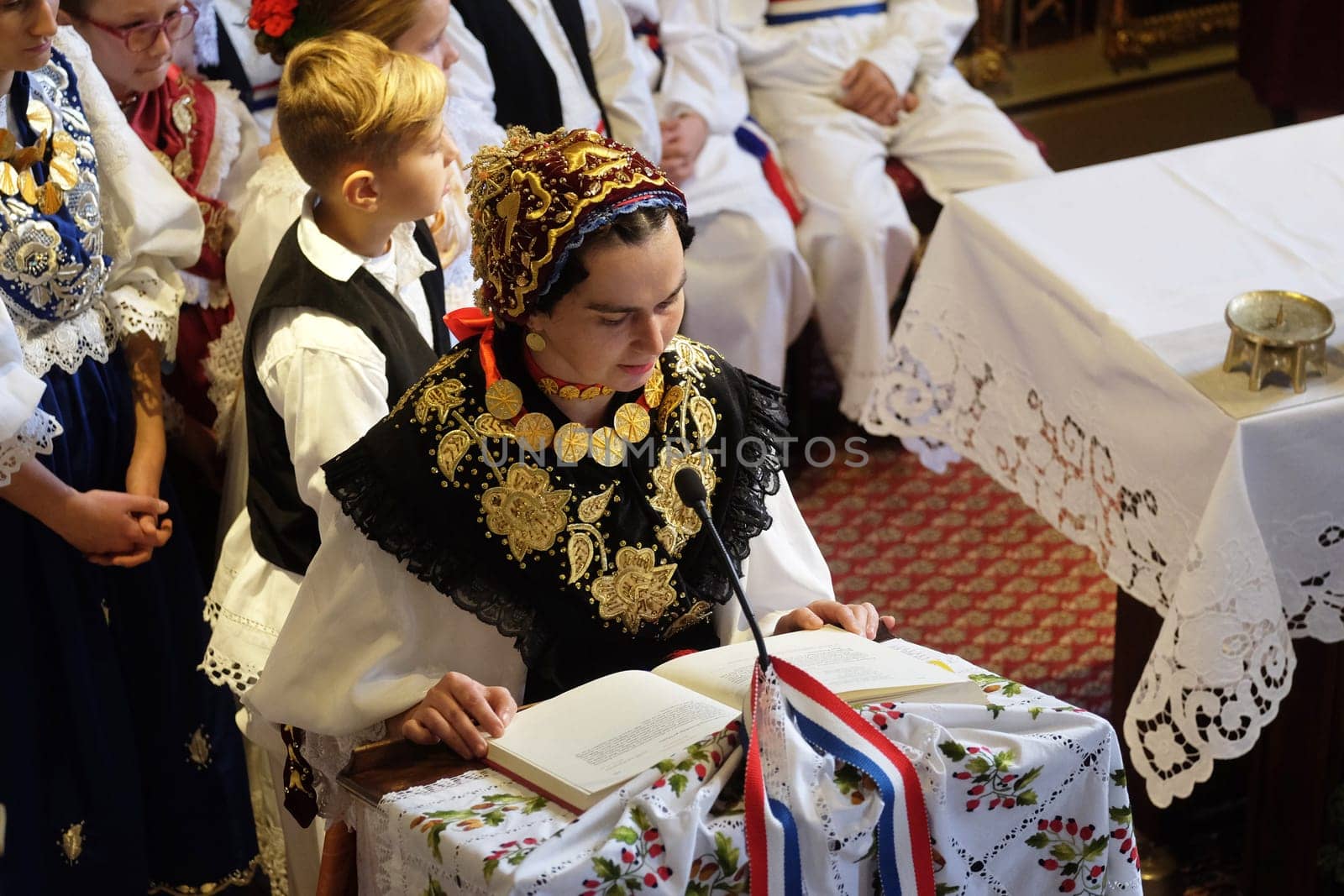 Woman dressed in traditional regional folk costumes in the church at the Mass on Thanksgiving day in Stitar, Croatia