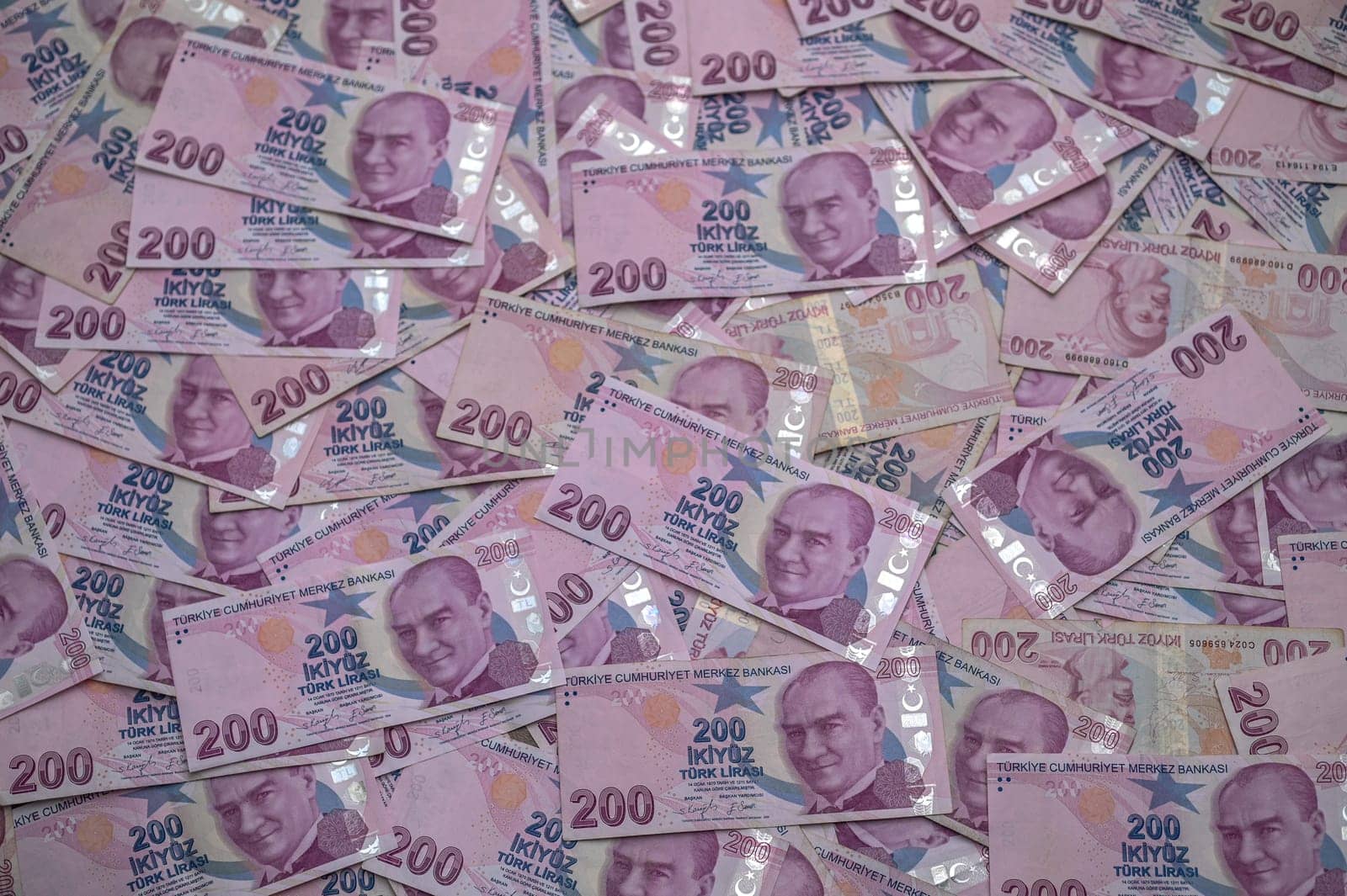 Stacks of Turkish banknotes create a vivid display, highlighting the intricate designs and notable figures on each bill.