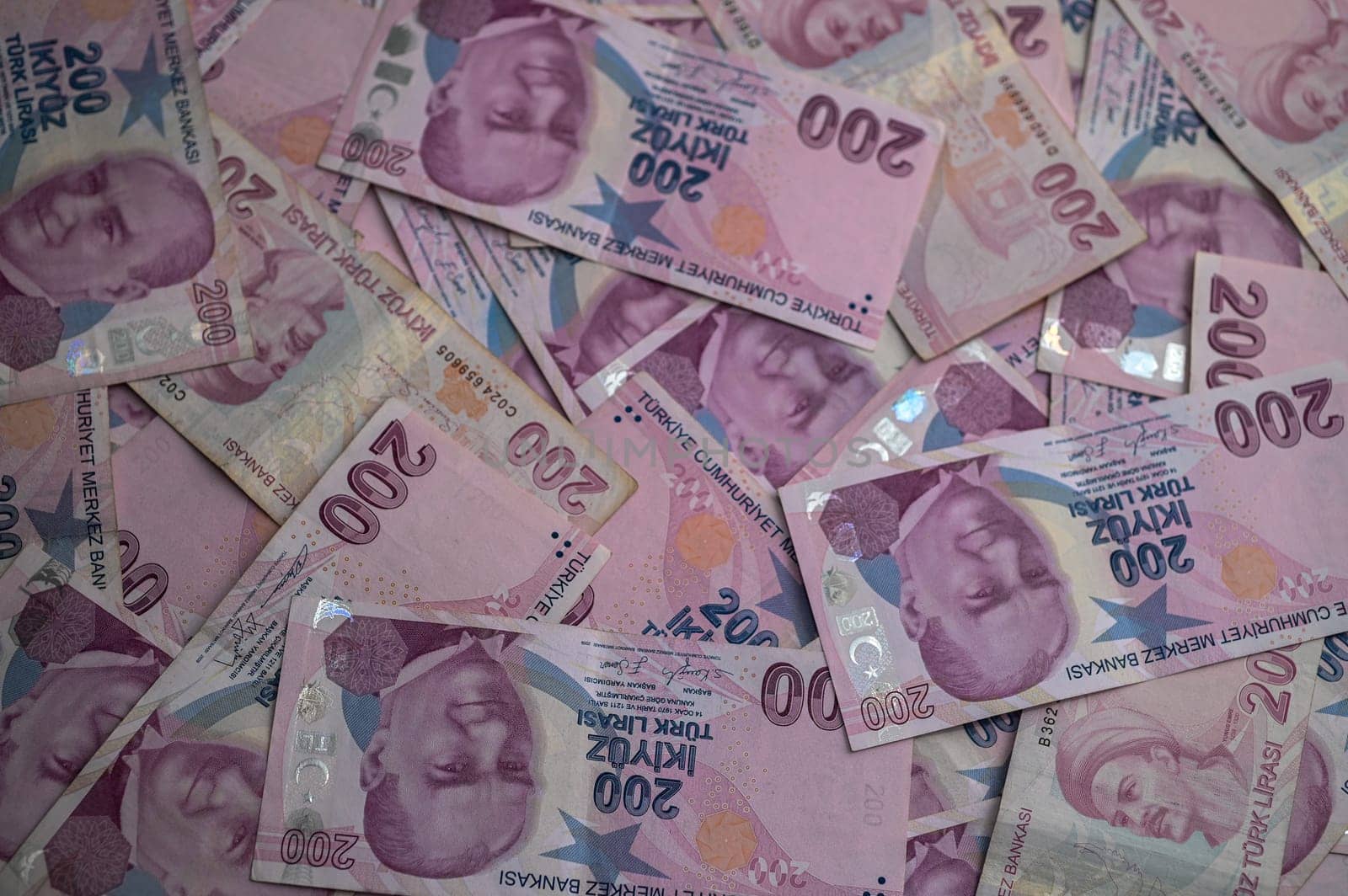 A vibrant collection of pink currency bills fills the view, showcasing intricate designs and various denominations.