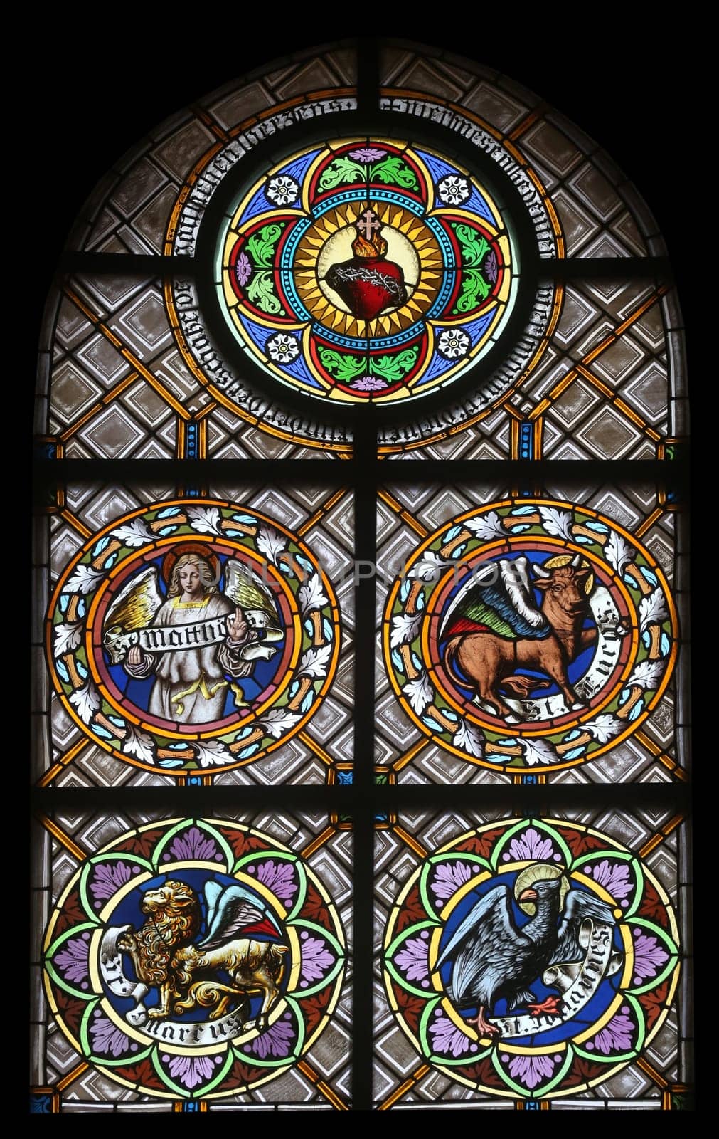 Symbols of the Evangelists, stained glass window in the parish church of St. Peter and Paul in Oberstaufen, Germany