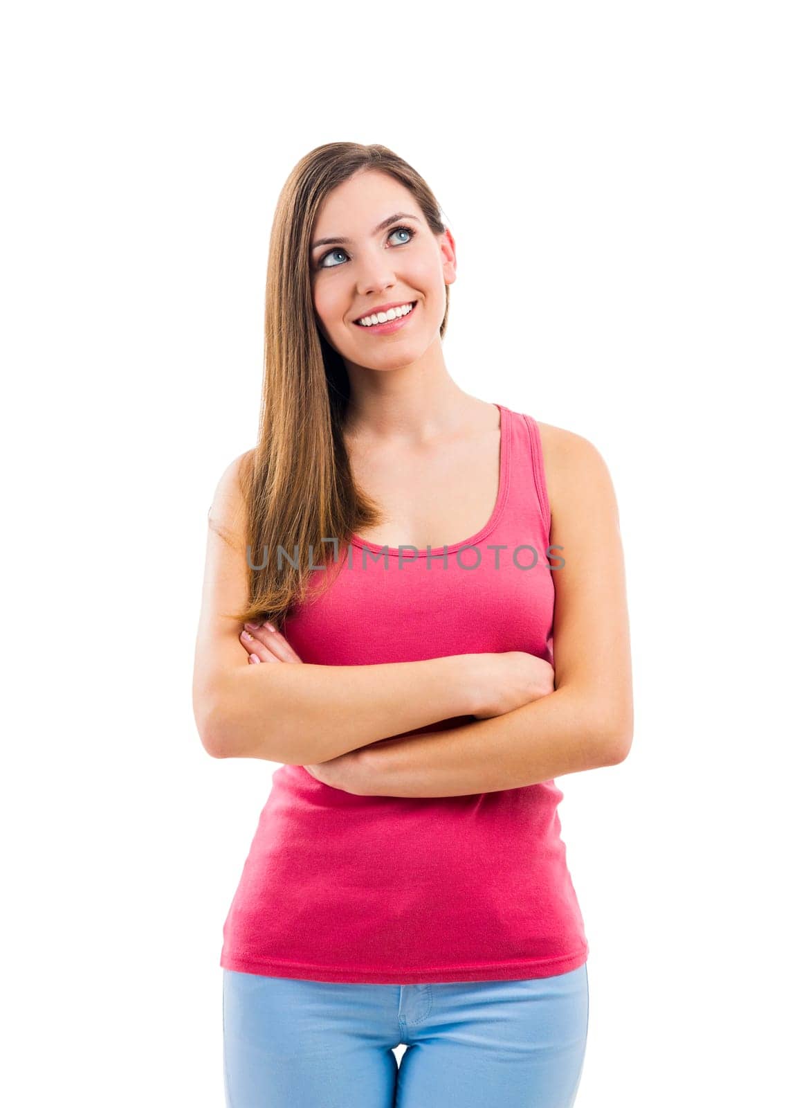 Beautiful brunette woman laughing and pointing to the side, isolated over white background