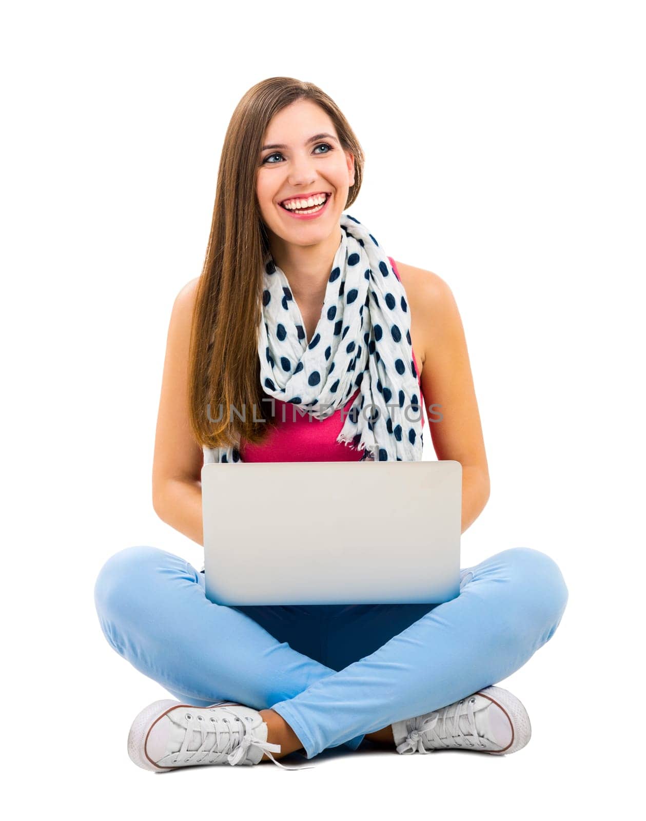 Beautiful woman sitting with crossed legs working with a laptop