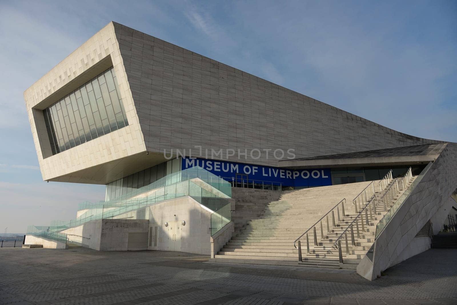 Liverpool, United Kingdom, 2nd February, 2020: Striking modern architecture of the Museum of Liverpool lit by evening sun with a blue color theme.