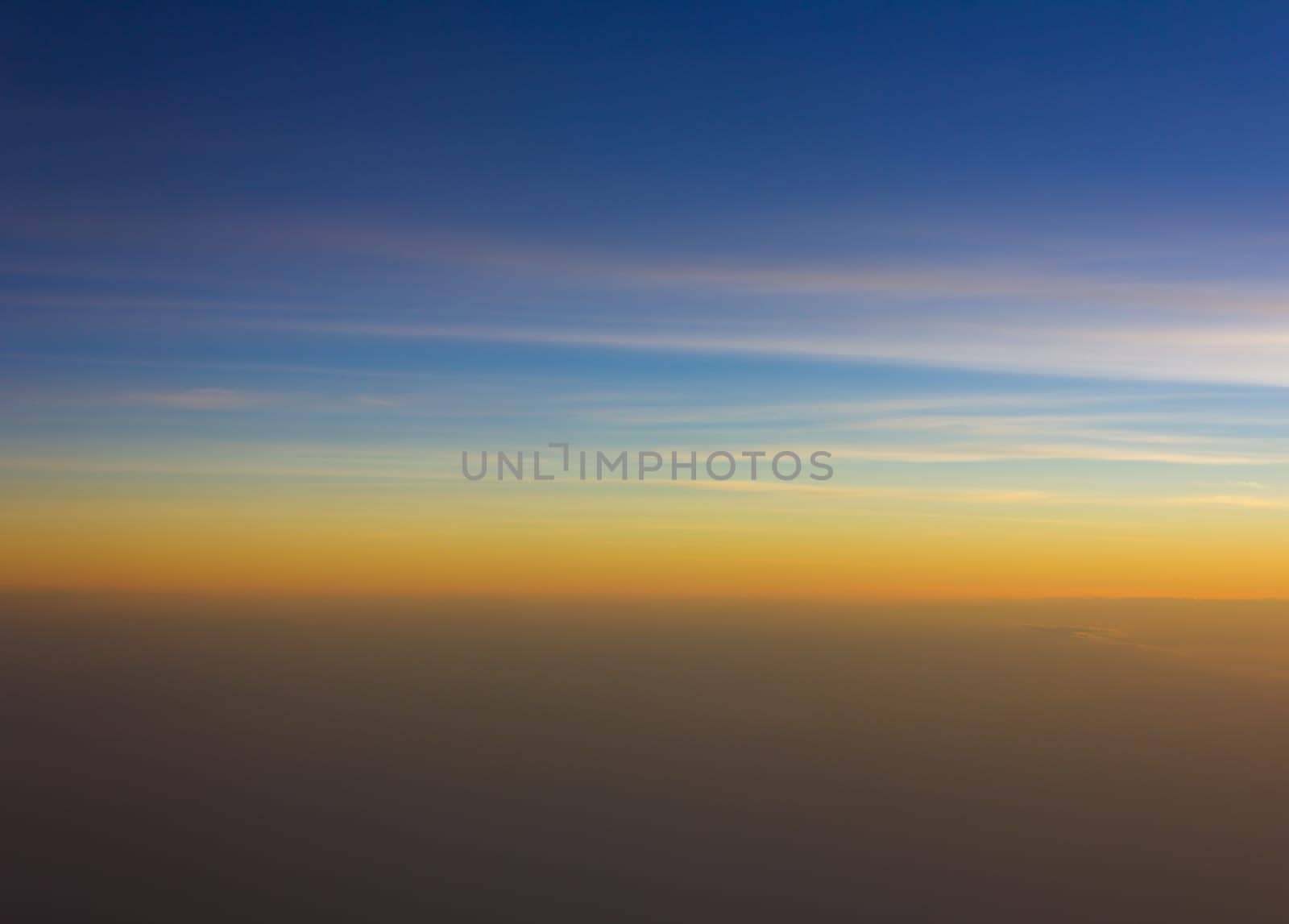 Sky and clouds at sunset bird's eye view on the plane