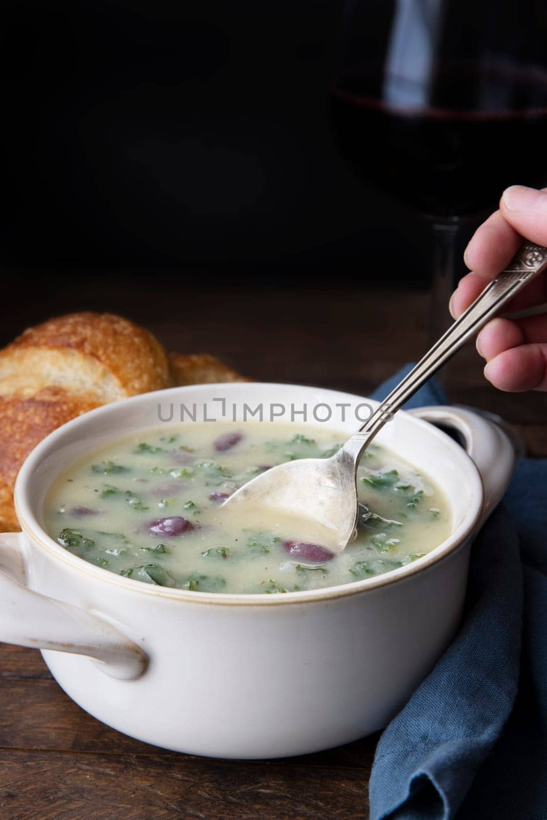 Portuguese Caldo Verde soup with spoon.  Vertical format with copy space.